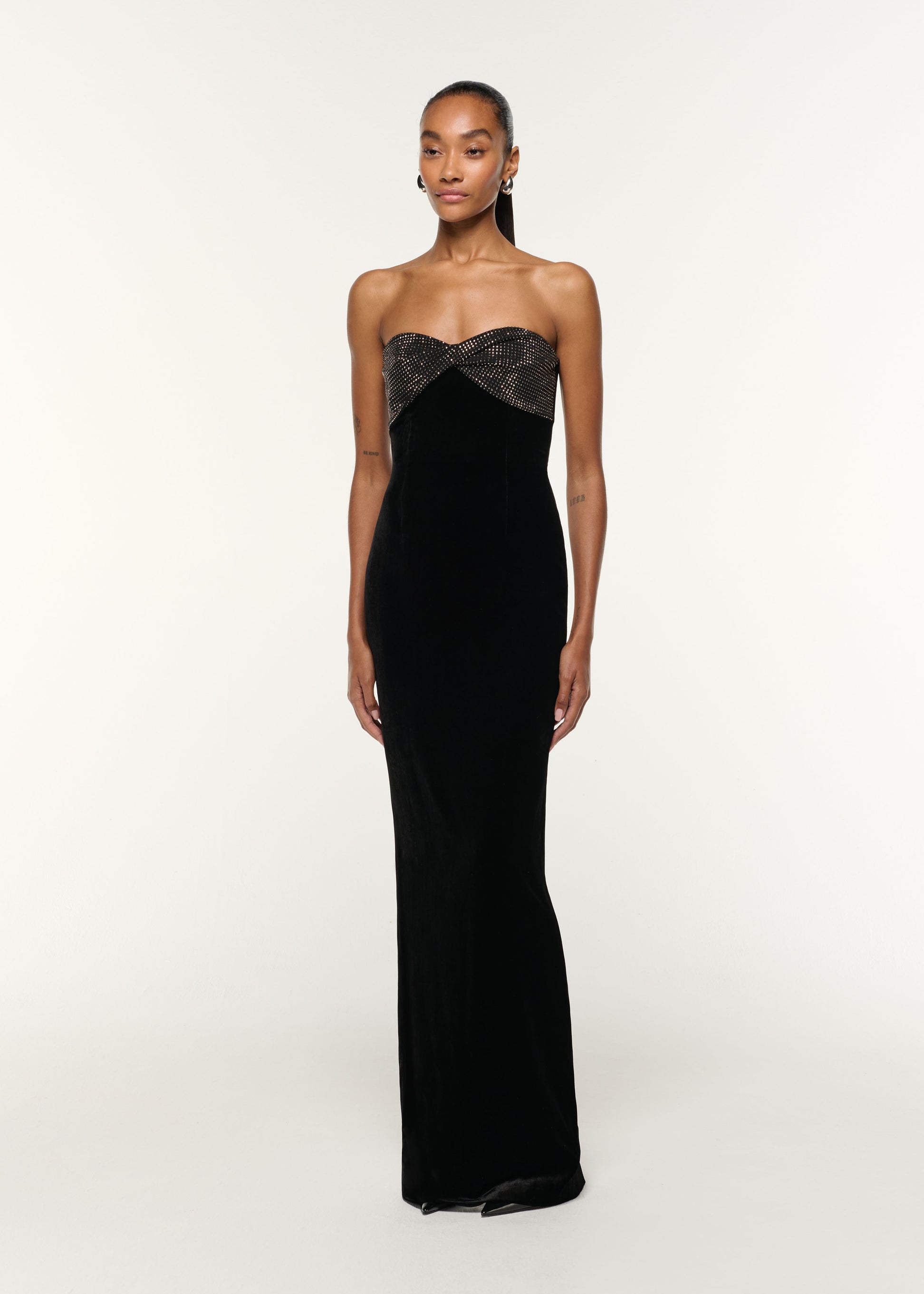 Side view of a model wearing the Diamante Twist Drape Velvet Column Gown in Black