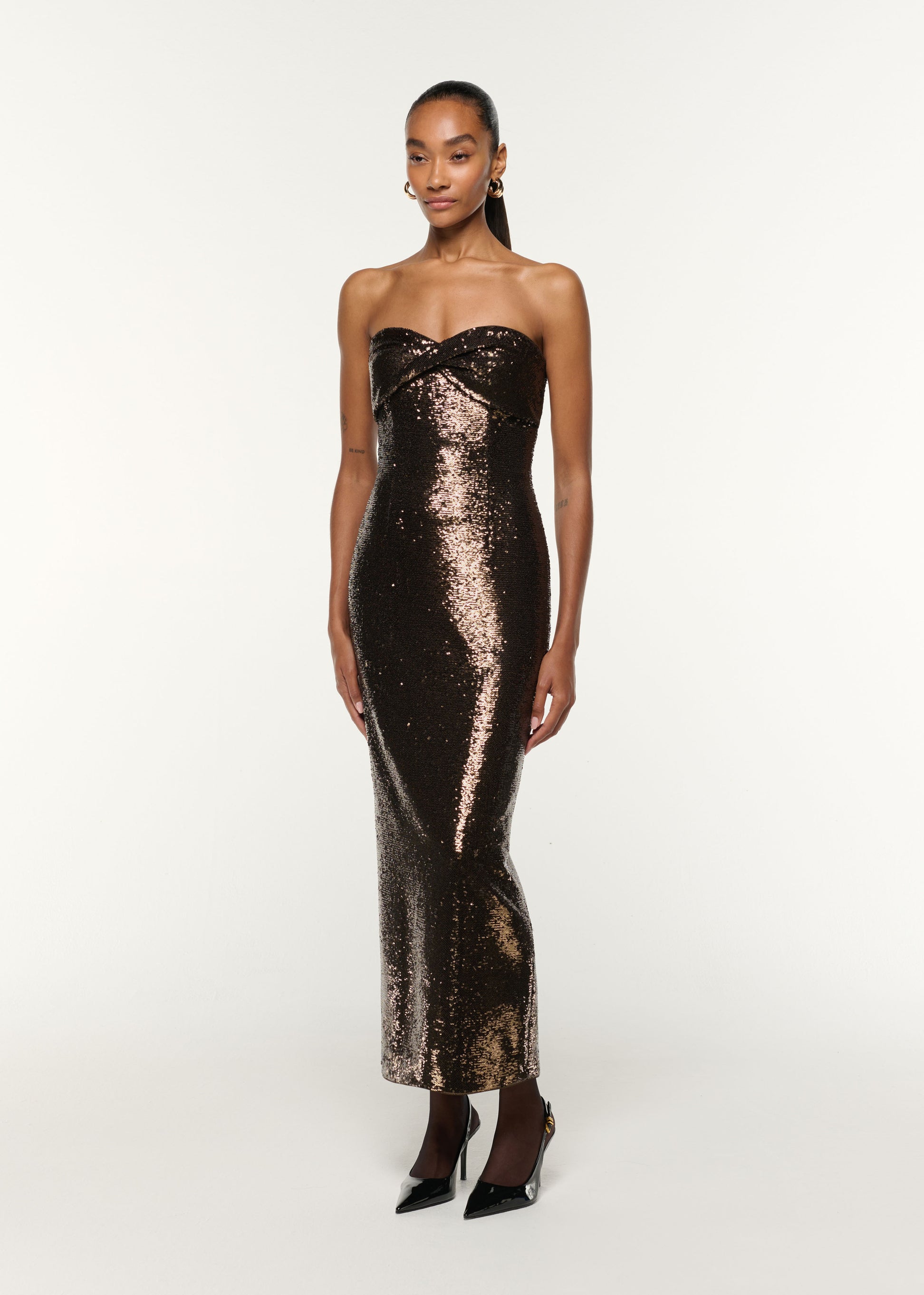 Side view of a model wearing the Twist Drape Sequin Dress in Bronze