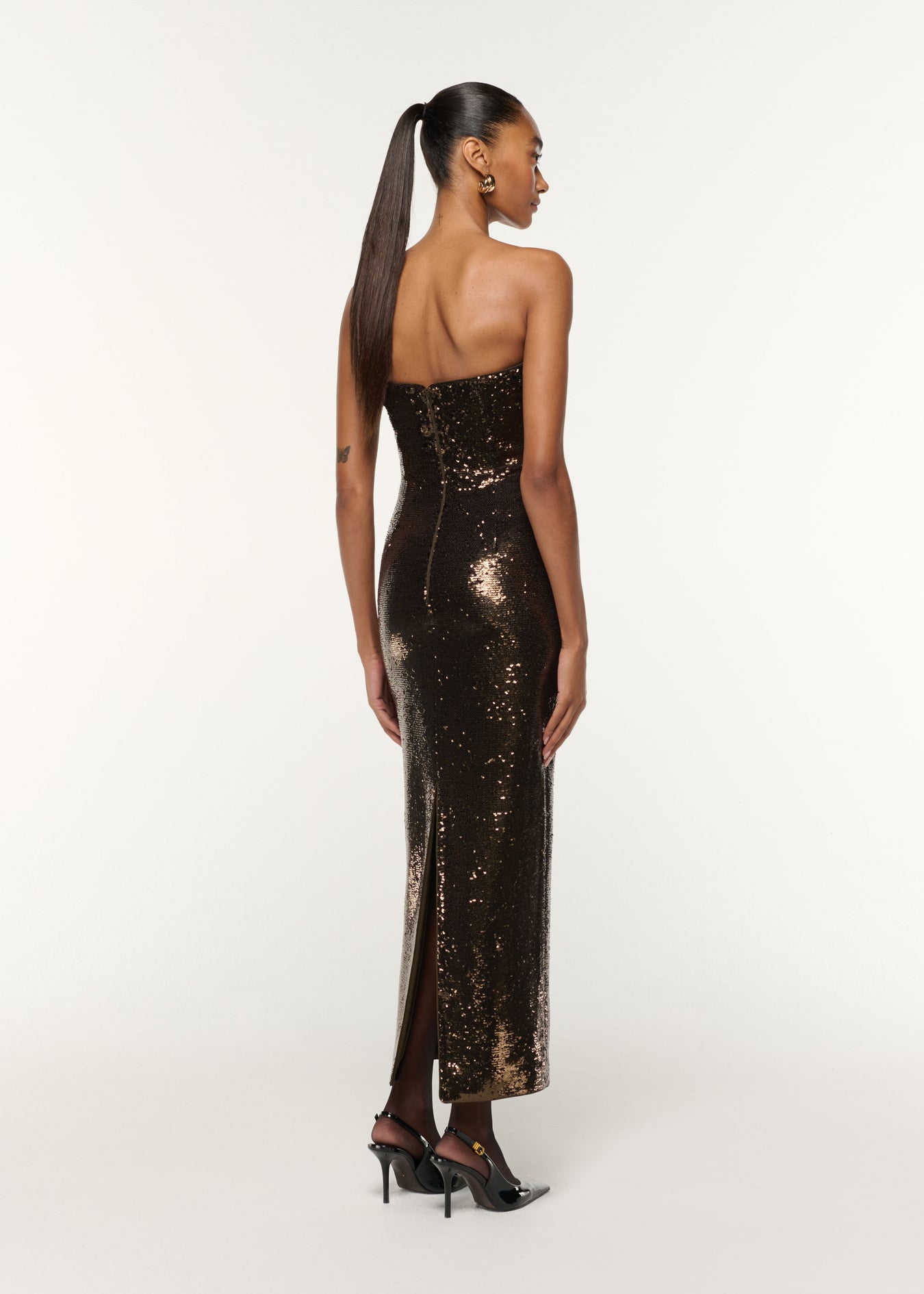 Back view of a model wearing the Twist Drape Sequin Dress in Bronze