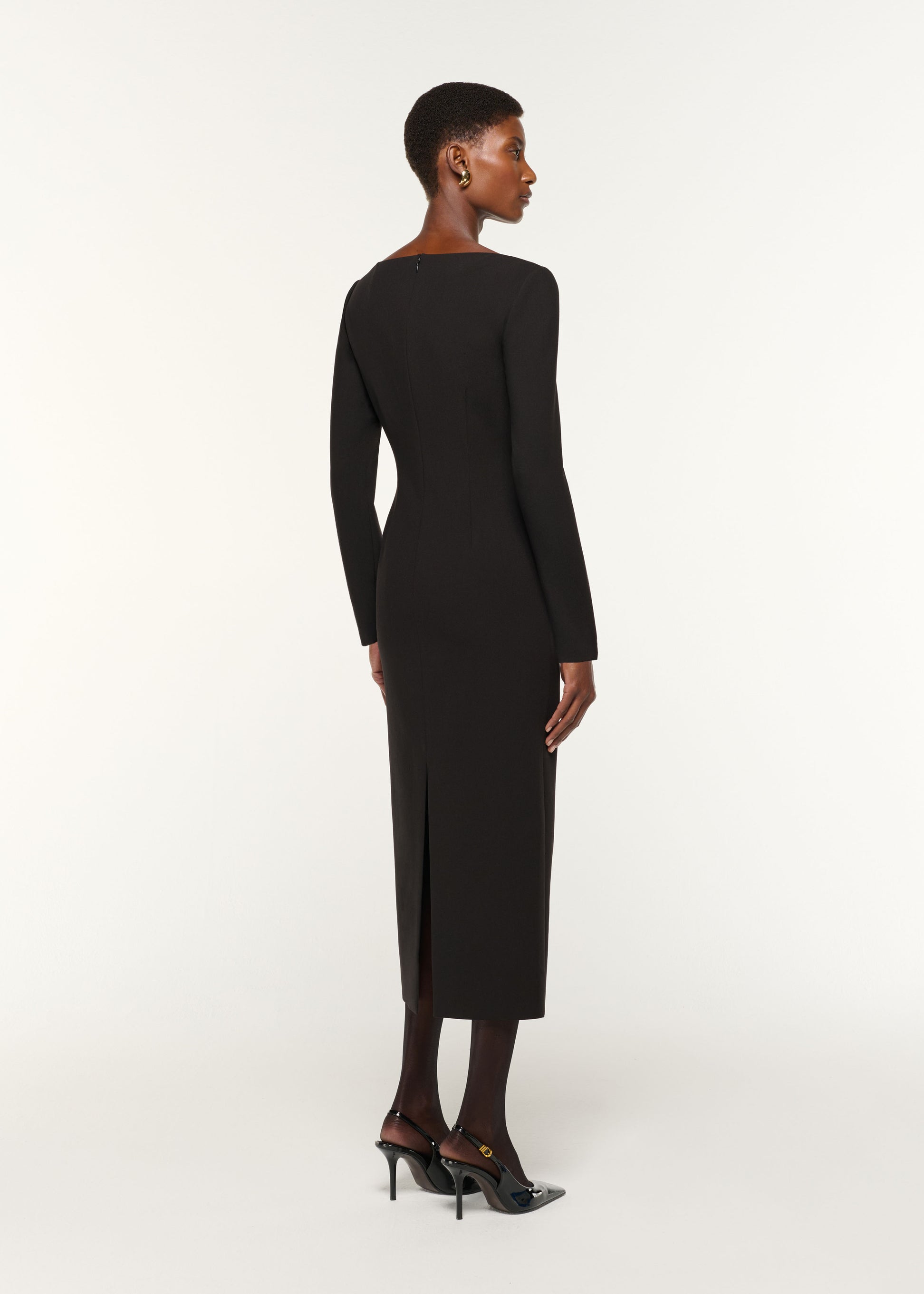 Back view of a model wearing the Twist Drape Stretch Crepe Dress in Black