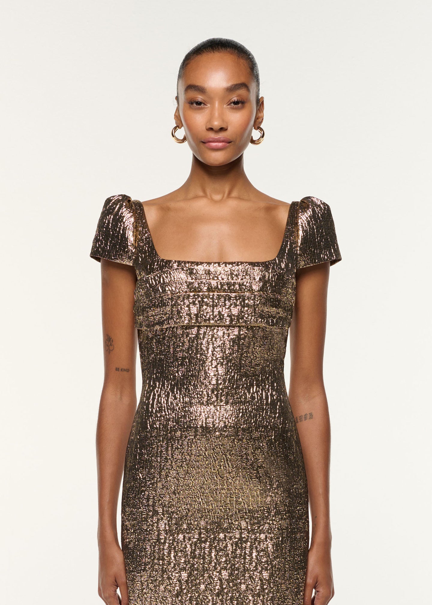 Close up of a model wearing the Pleated Drape Metallic Jacquard Dress in Gold