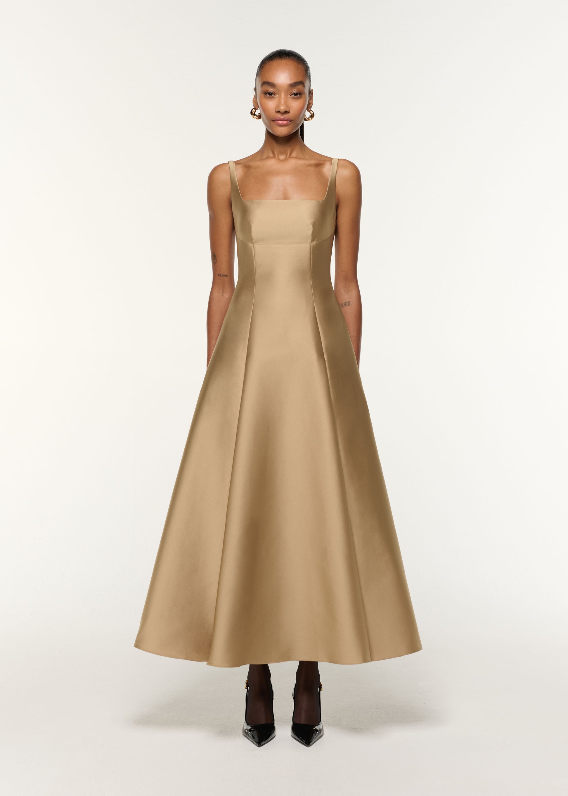 Front view of a model wearing the Square Neckline Taffeta Dress in Gold