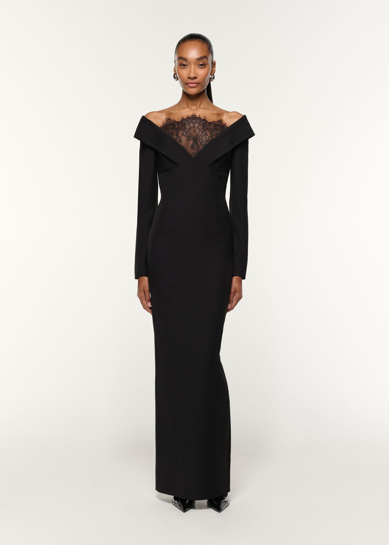 Front view of a model wearing the Lace Insert Crepe Column Gown in Black