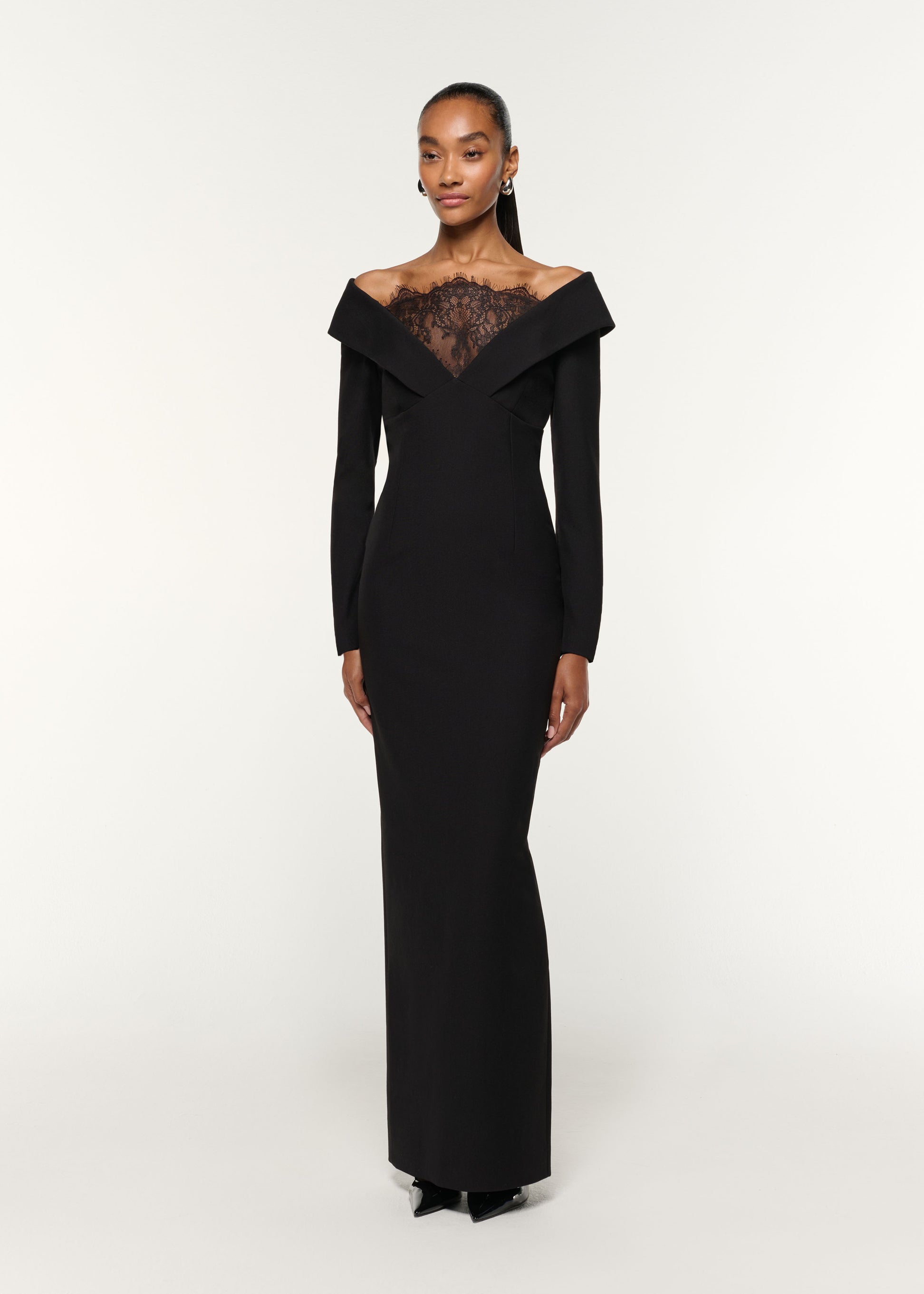 Side view of a model wearing the Lace Insert Crepe Column Gown in Black