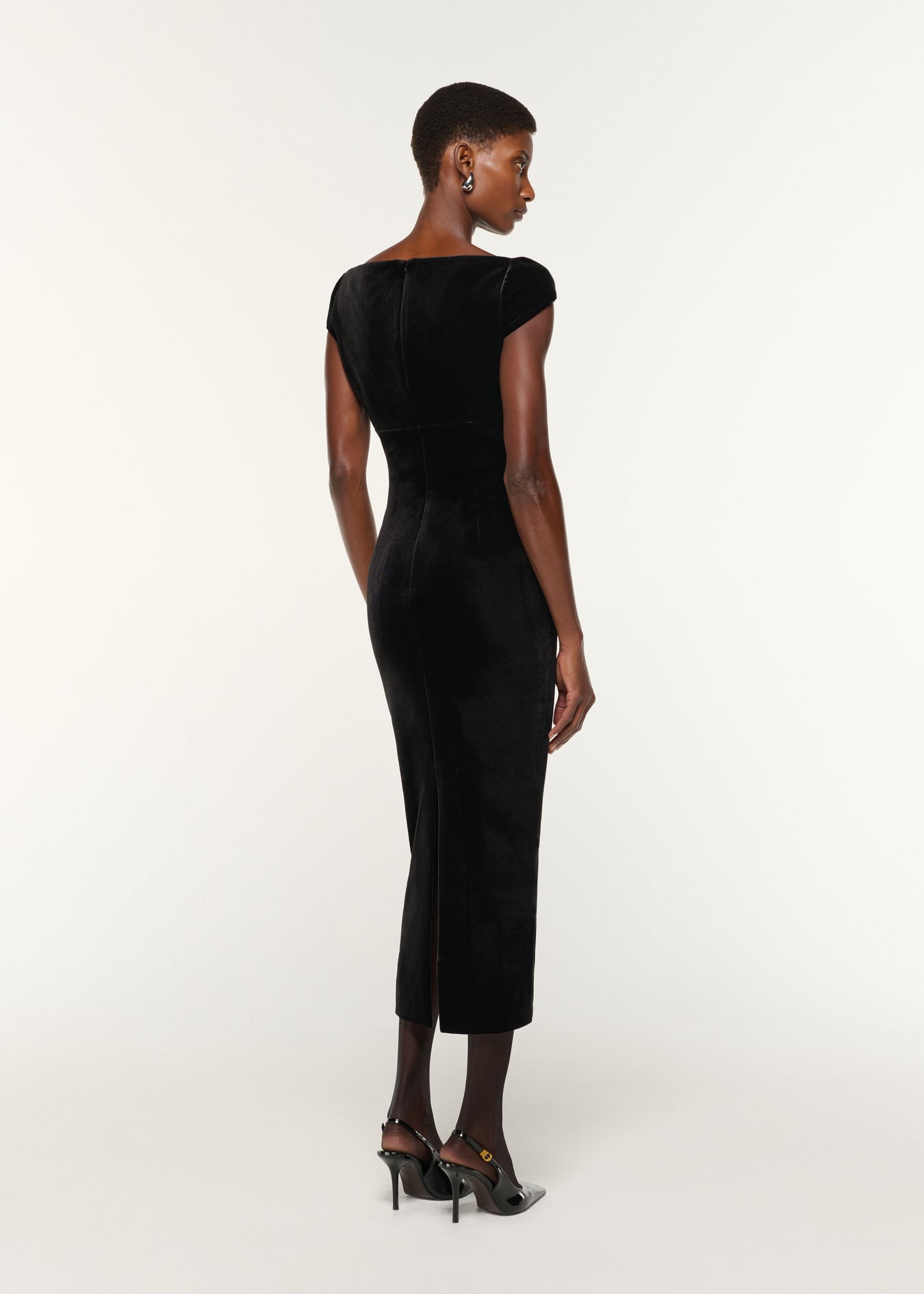 Back view of a model wearing the Lace Insert Scuba Velvet Dress in Black