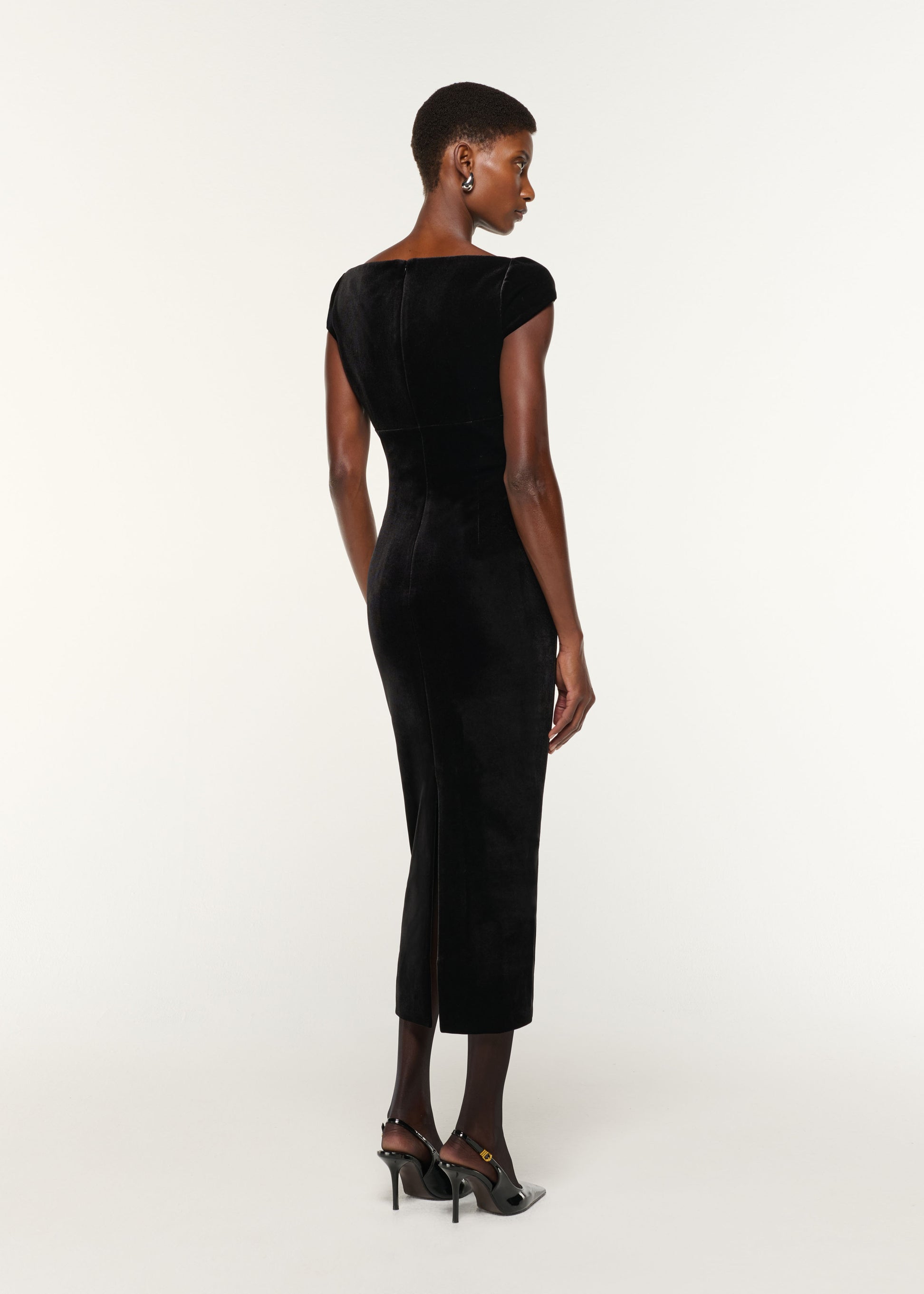 Back view of a model wearing the Lace Insert Scuba Velvet Dress in Black