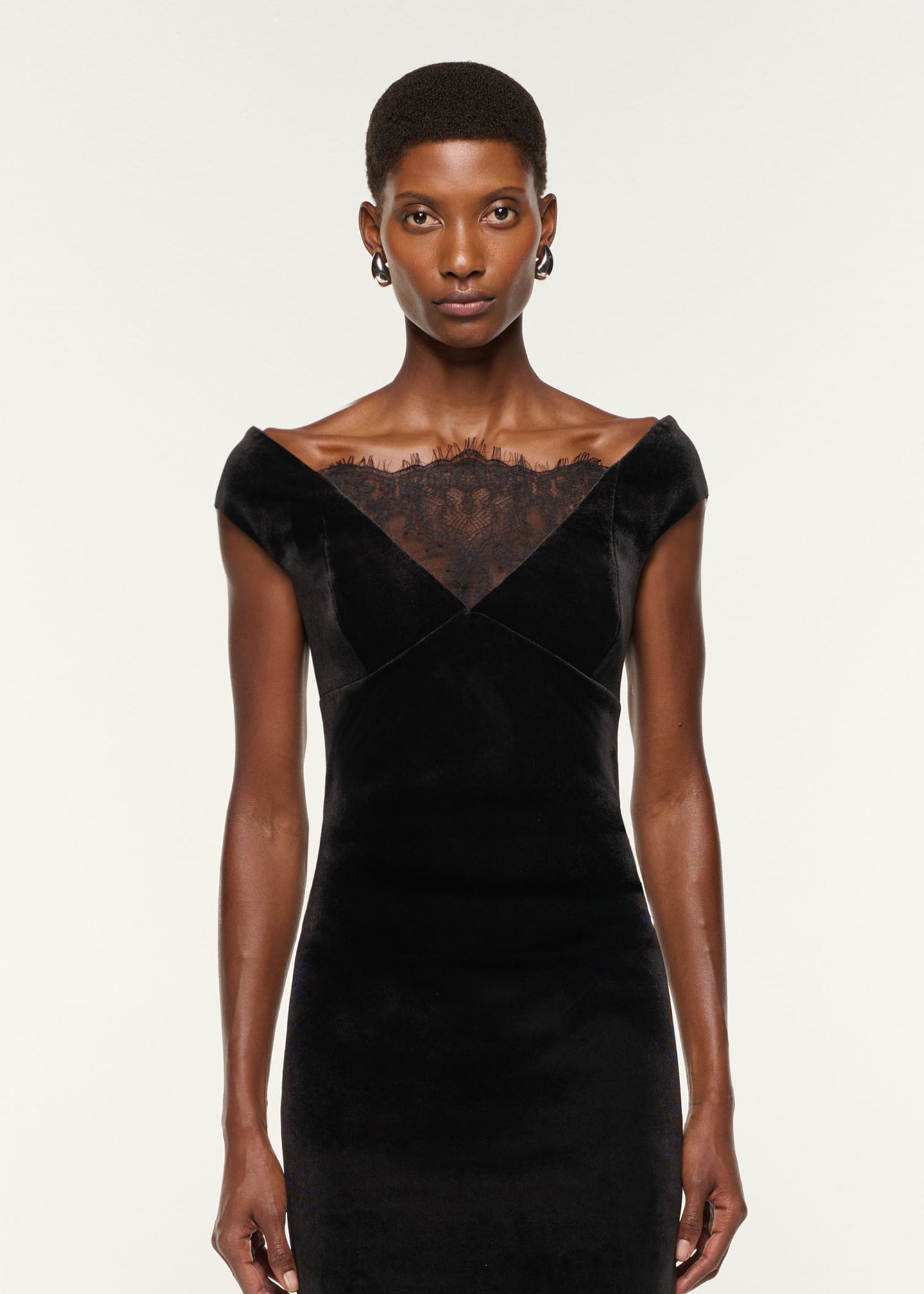 Close up of a model wearing the Lace Insert Scuba Velvet Dress in Black