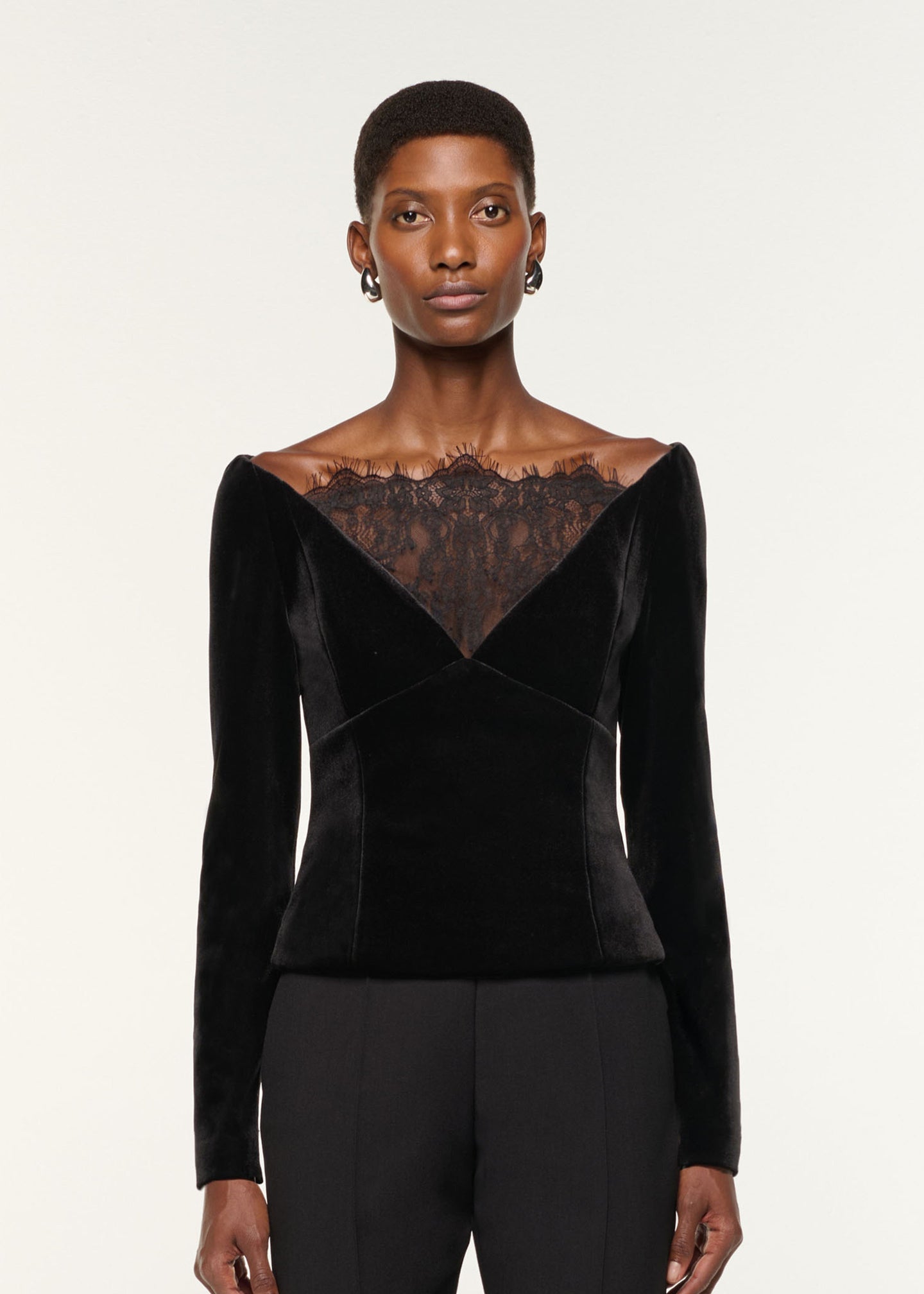 Close up of a model wearing the Lace Insert Scuba Velvet Top in Black