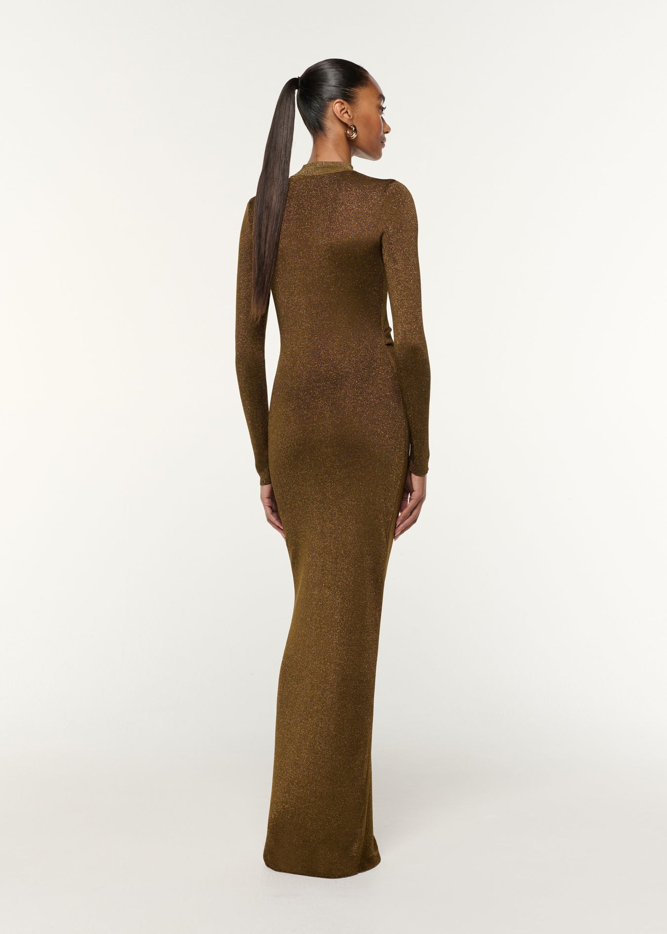 Back view of a model wearing the Lurex Knit Drape & Metal Trim Dress in Khaki