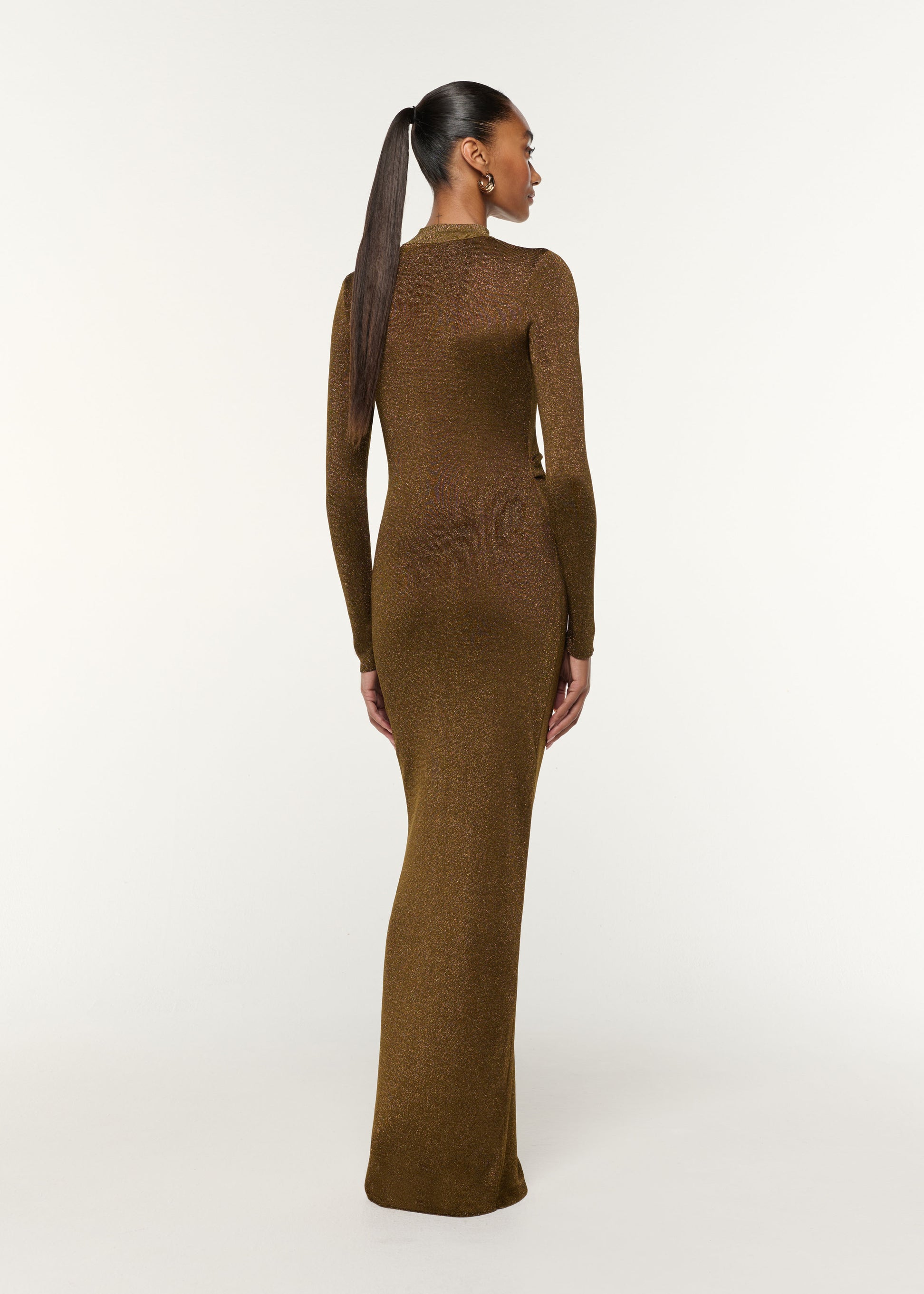 Back view of a model wearing the Lurex Knit Drape & Metal Trim Dress in Khaki