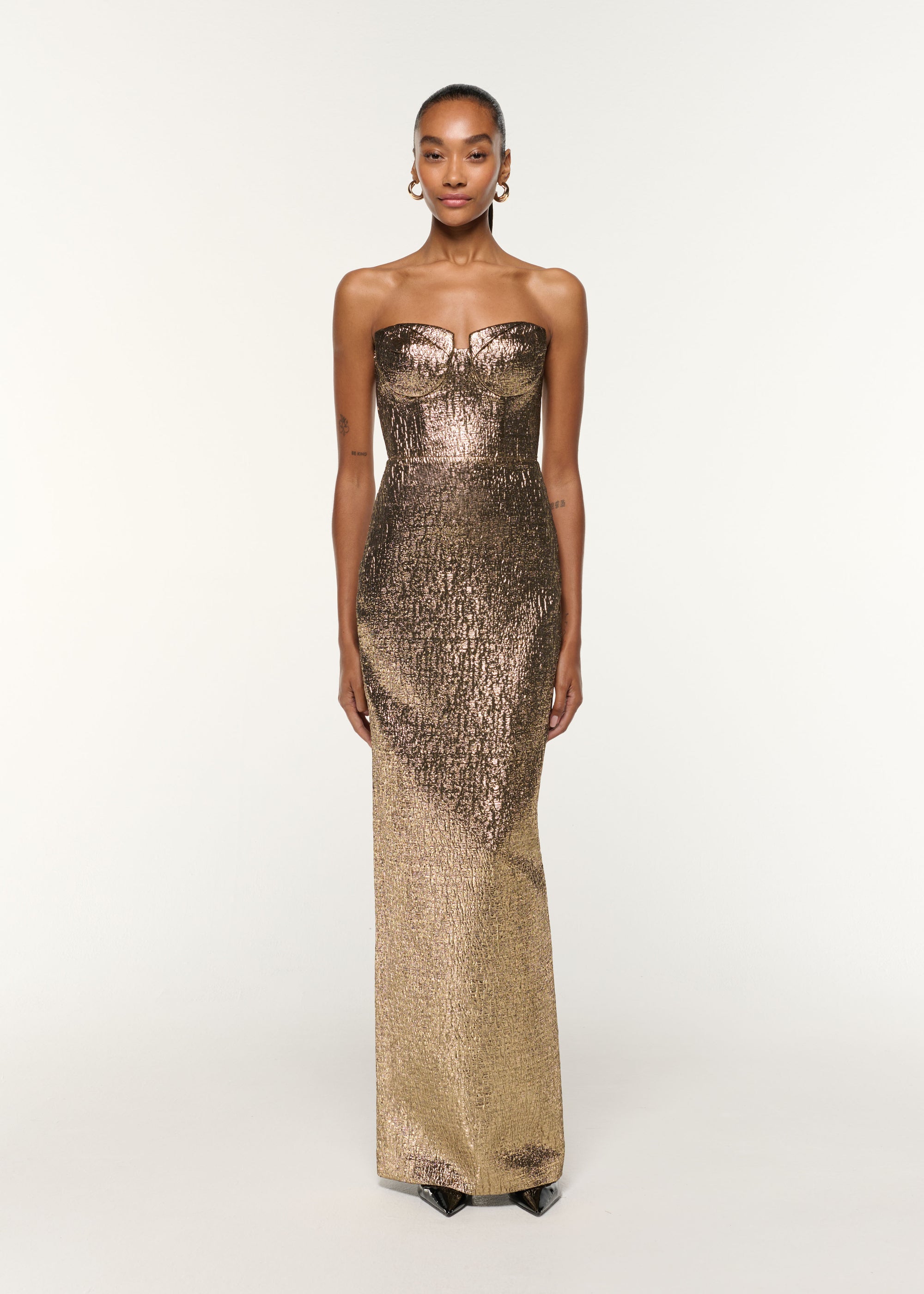 Front view of a model wearing the Pleated Bust Metallic Jacquard Gown in Gold