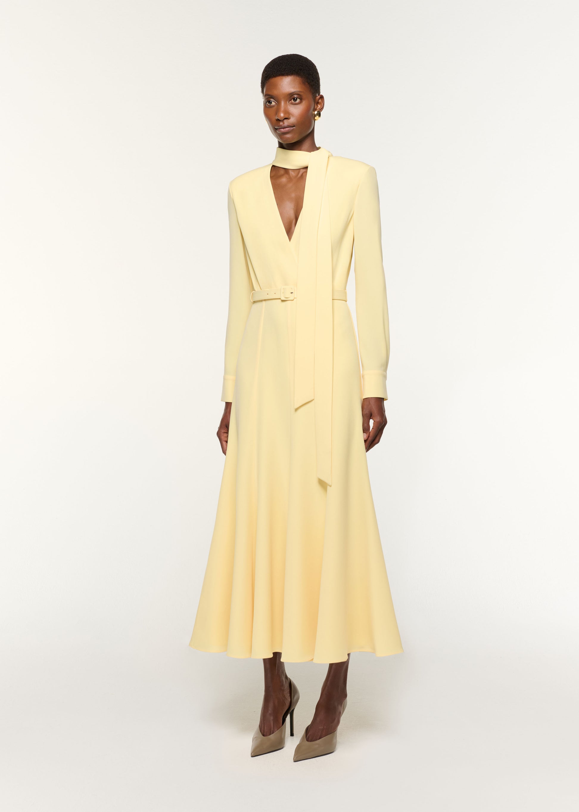 Side view of a model wearing the Light Cady Cut Out Dress in Yellow