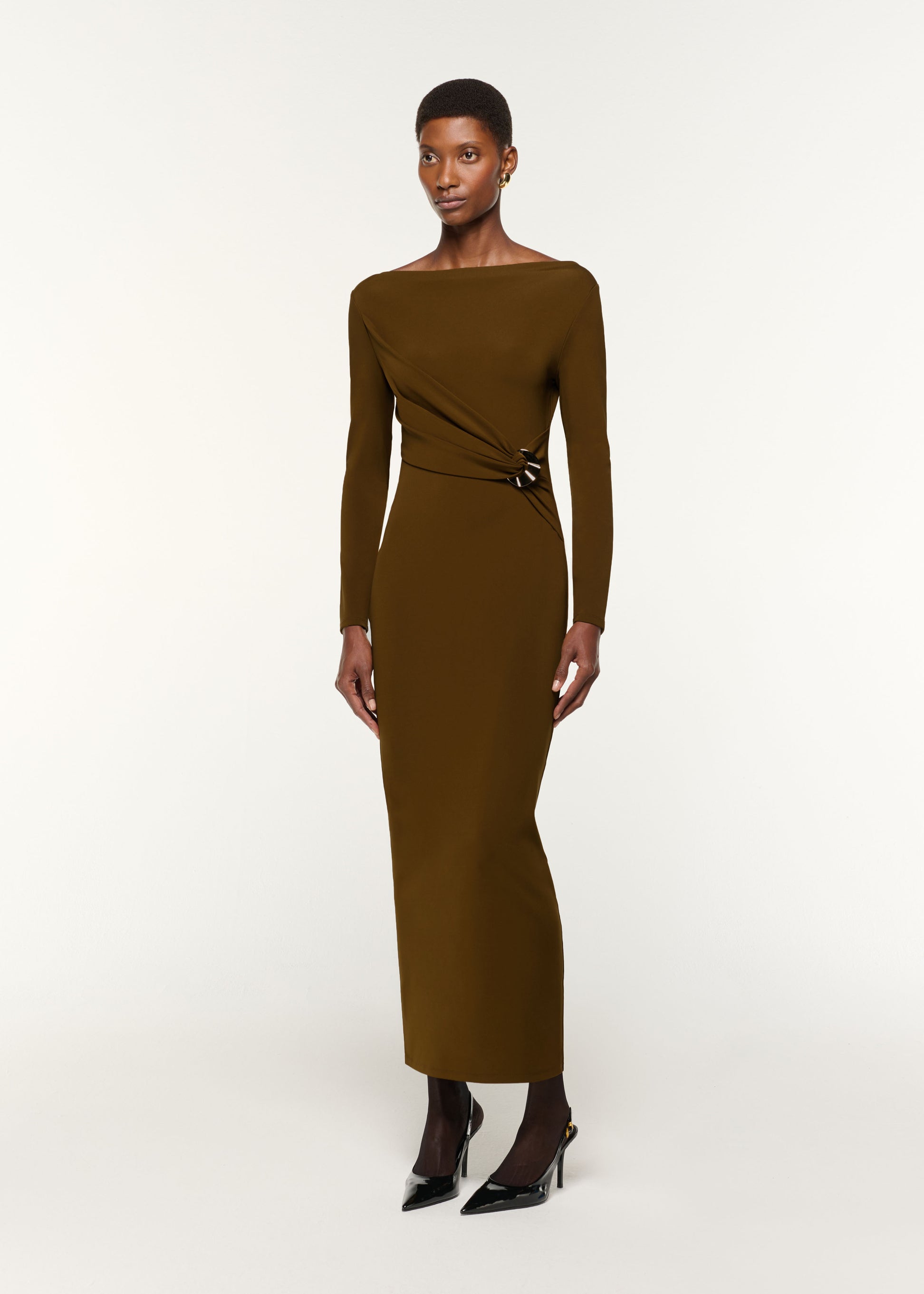 Side view of a model wearing the Jersey Twist Drape & Metal Trim Dress in Brown