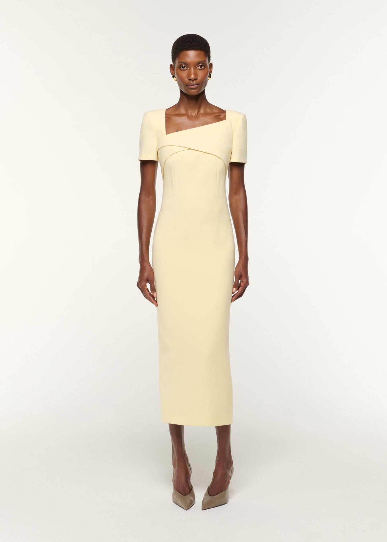 Front view of a model wearing the Asymmetric Drape Crepe Dress in Yellow