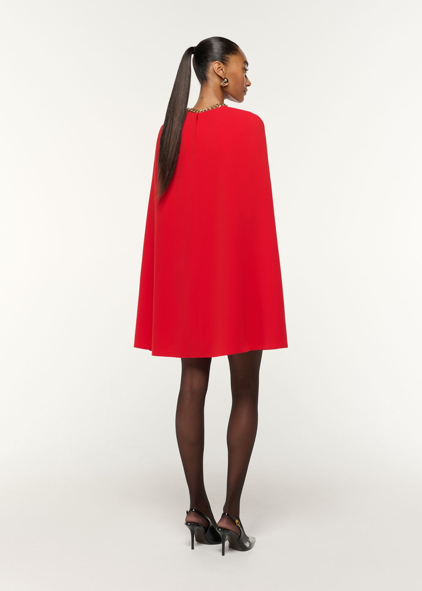 Back view of a model wearing the Light Cady Cape Dress in Red