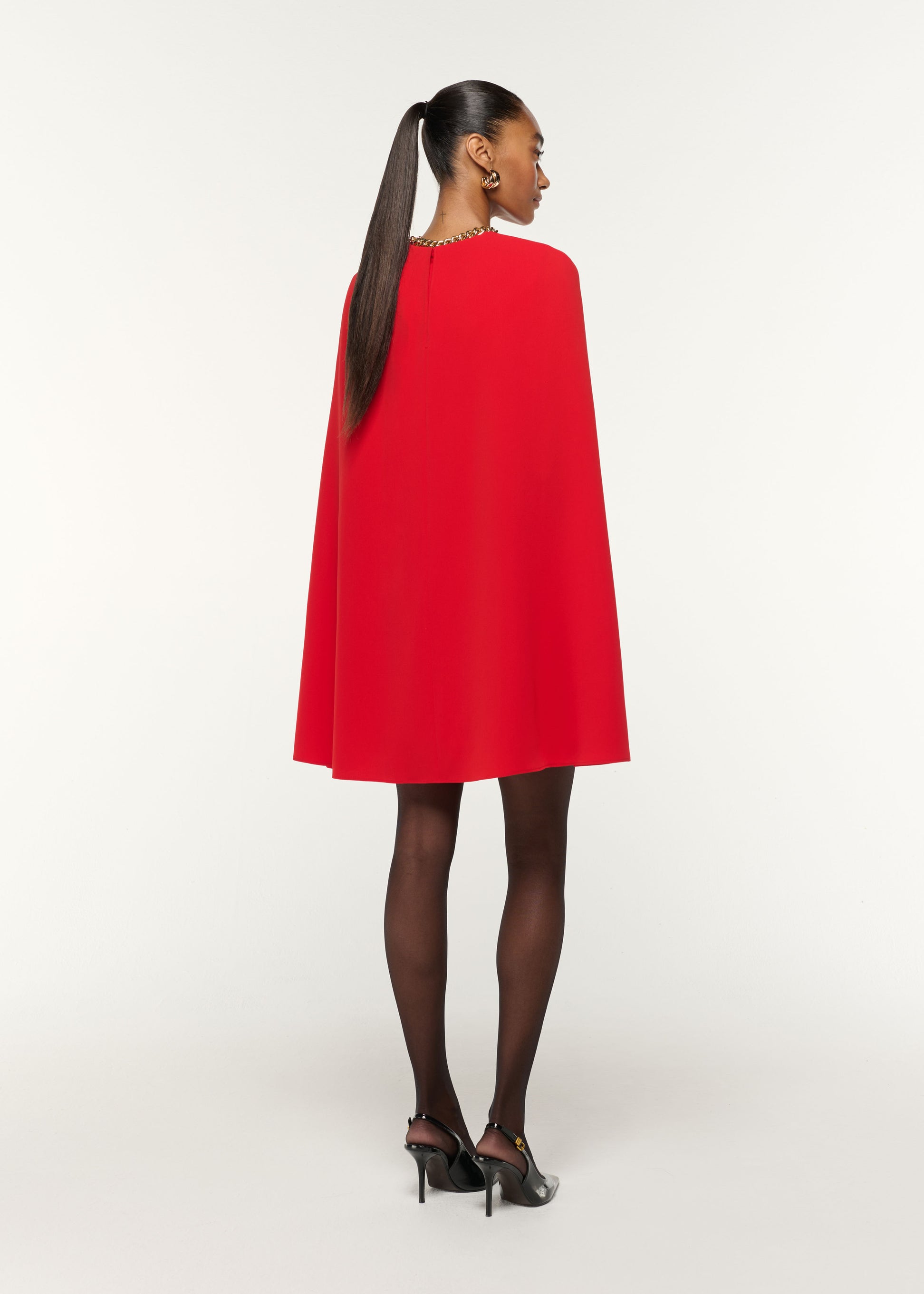 Back view of a model wearing the Light Cady Cape Dress in Red