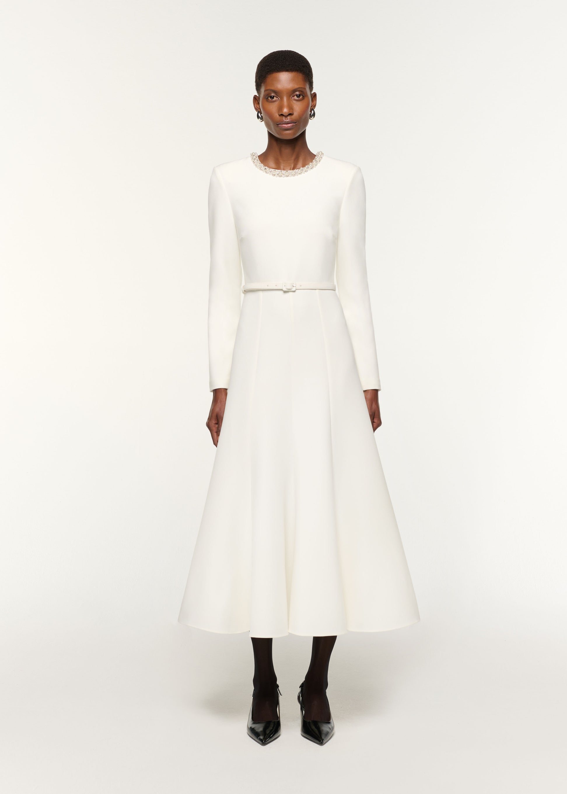 Front view of a model wearing the Crystal Neckline Crepe Dress in White