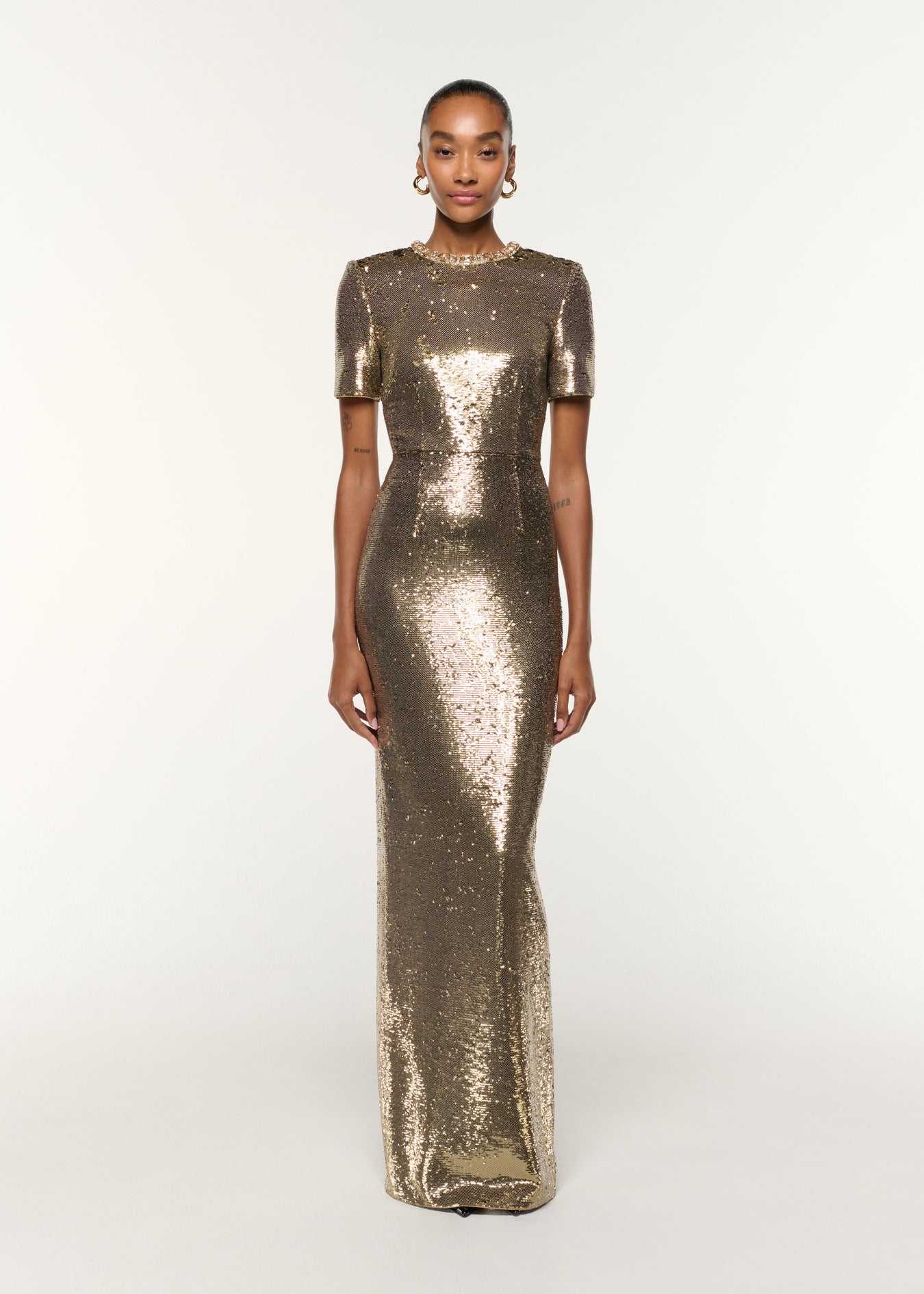 Front view of a model wearing the Crystal Neckline Sequin Column Gown in Gold