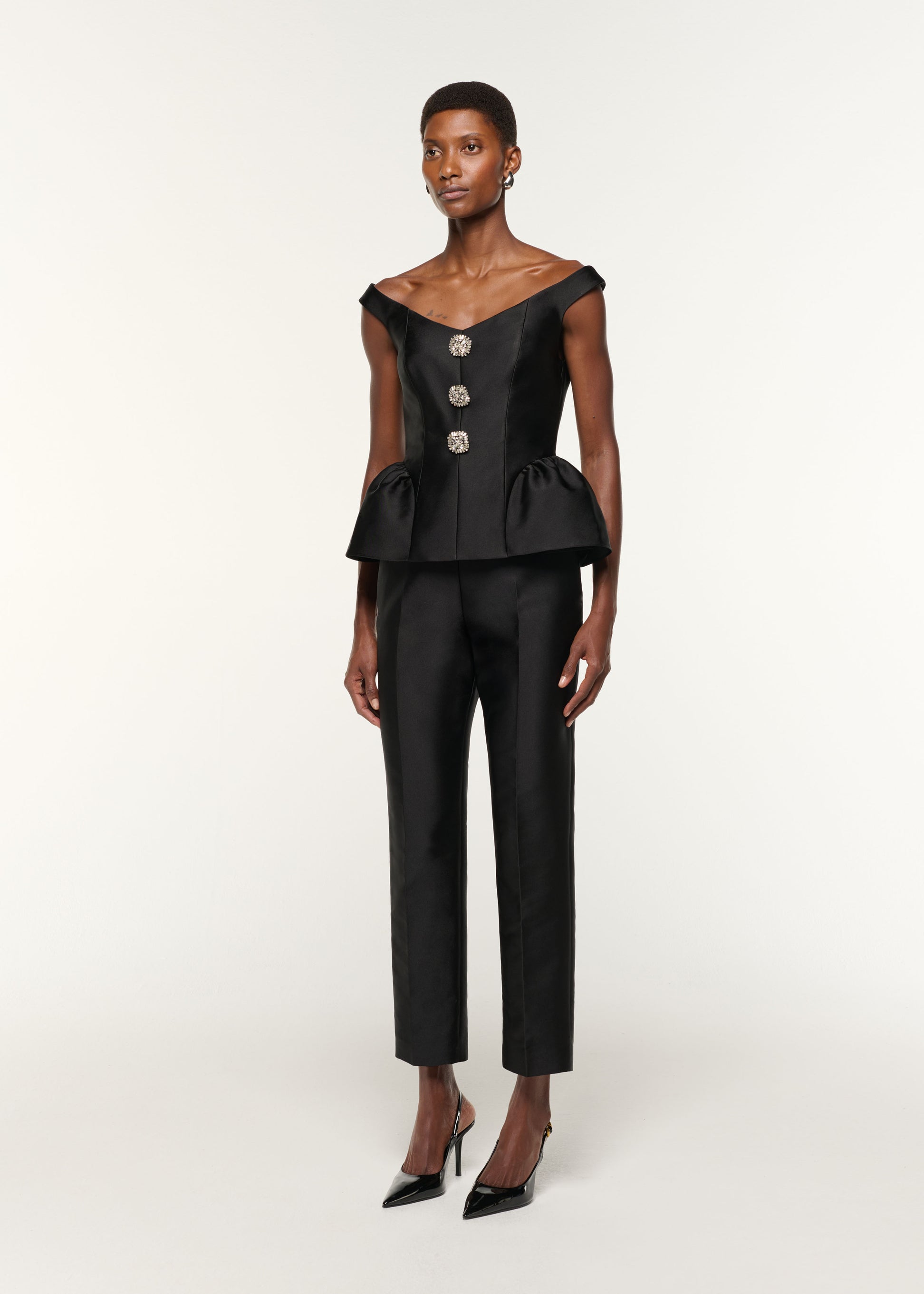 Side view of a model wearing the Taffeta Straight Leg Trouser in Black