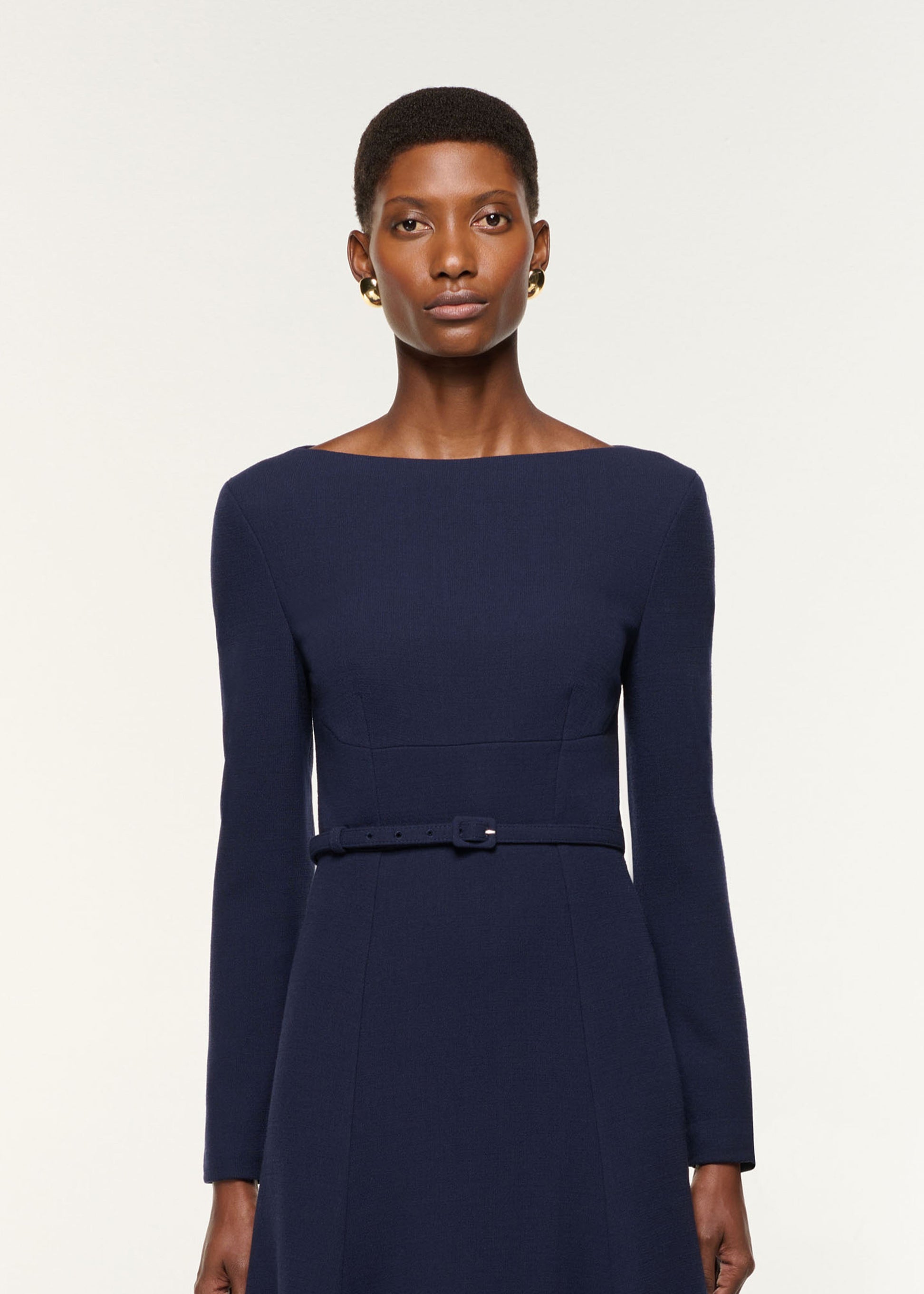Close up of a model wearing the Boat Neck Wool Crepe Dress in Navy