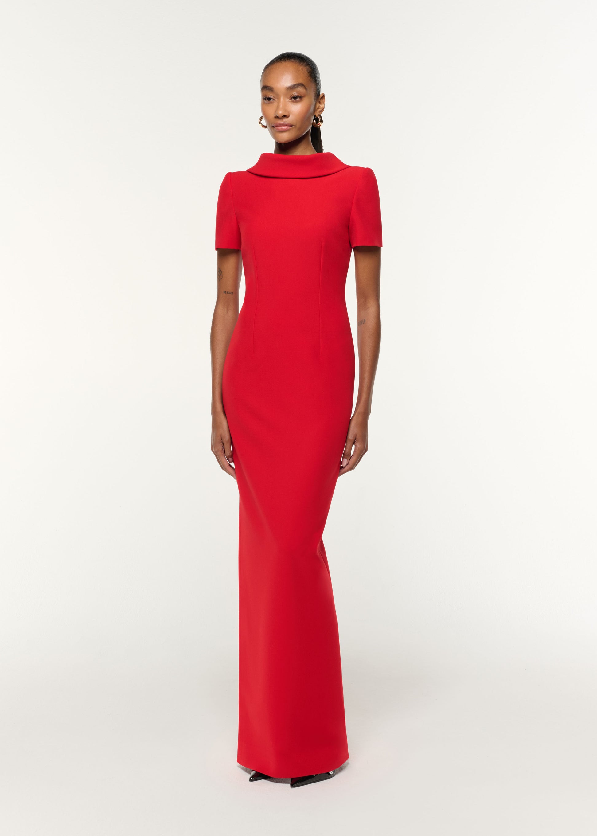 Side view of a model wearing the Collared Crepe Gown in Red