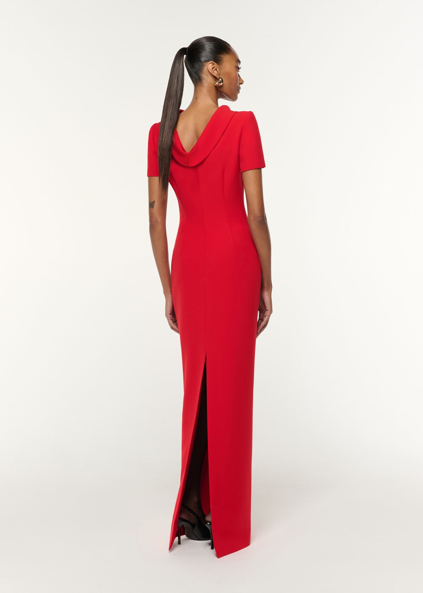 Back view of a model wearing the Collared Crepe Gown in Red