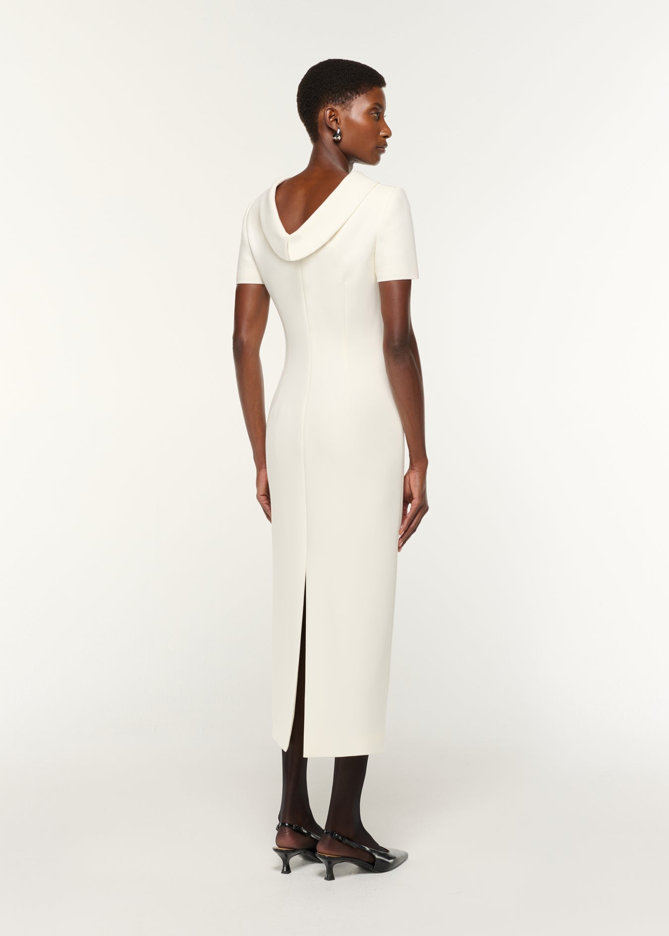 Back view of a model wearing the Collared Crepe Column Midi Dress in Cream