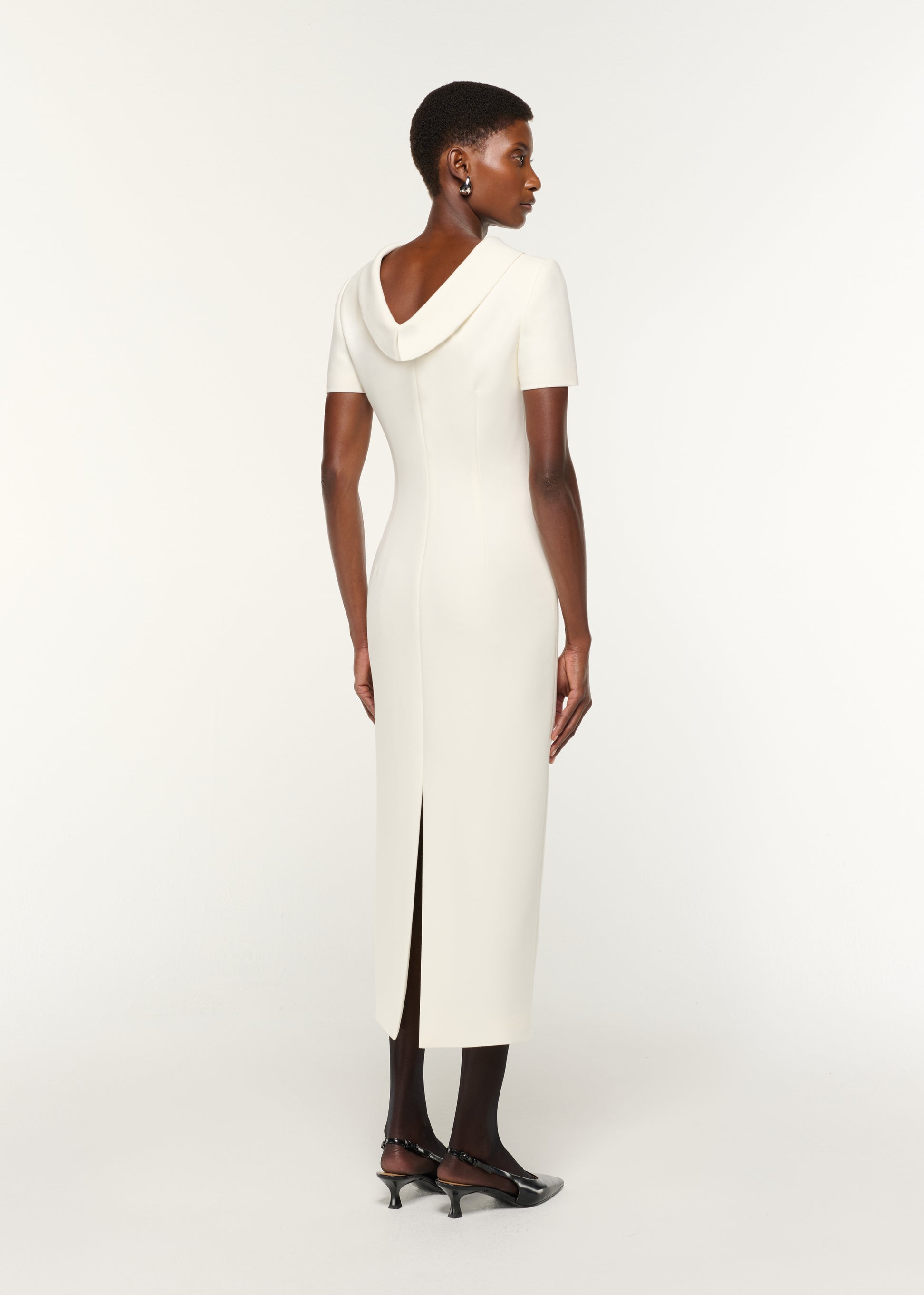 Back view of a model wearing the Collared Crepe Column Midi Dress in Cream