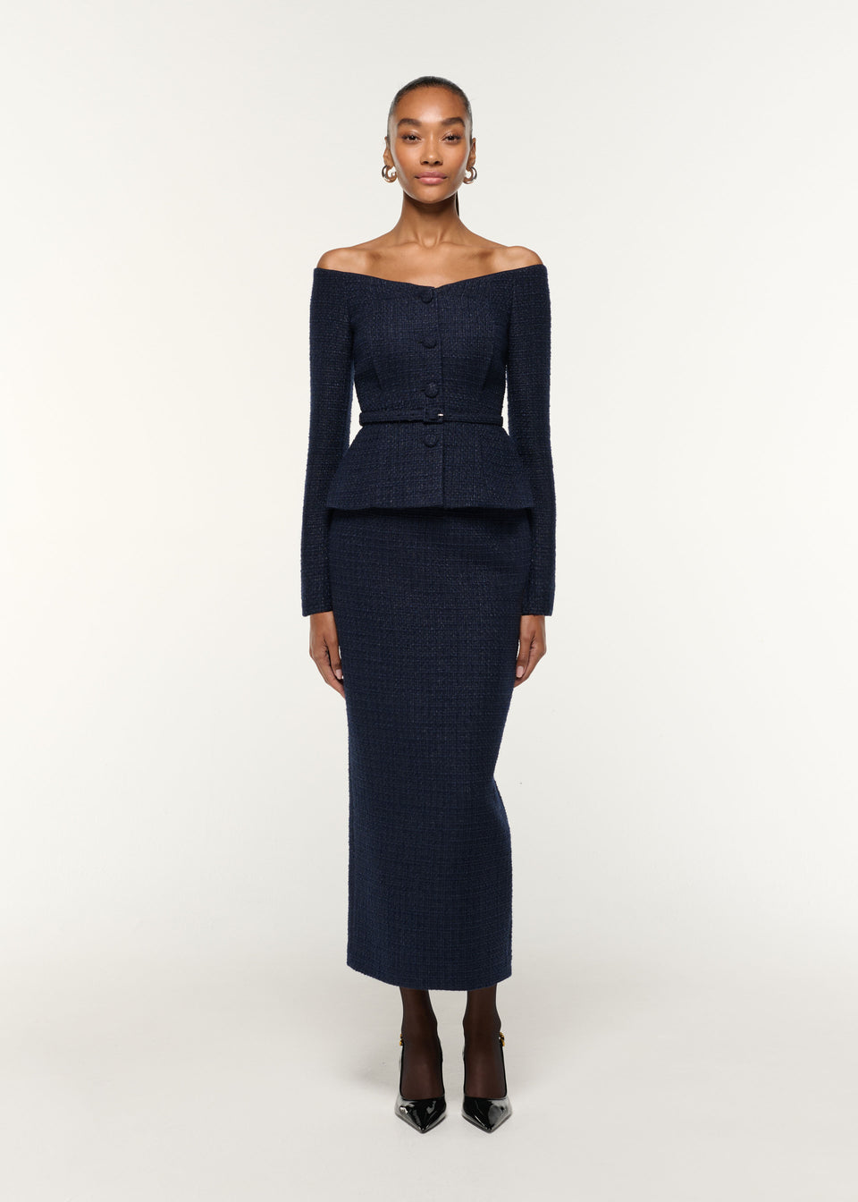 Front view of a model wearing the Boucle Column Skirt in Navy