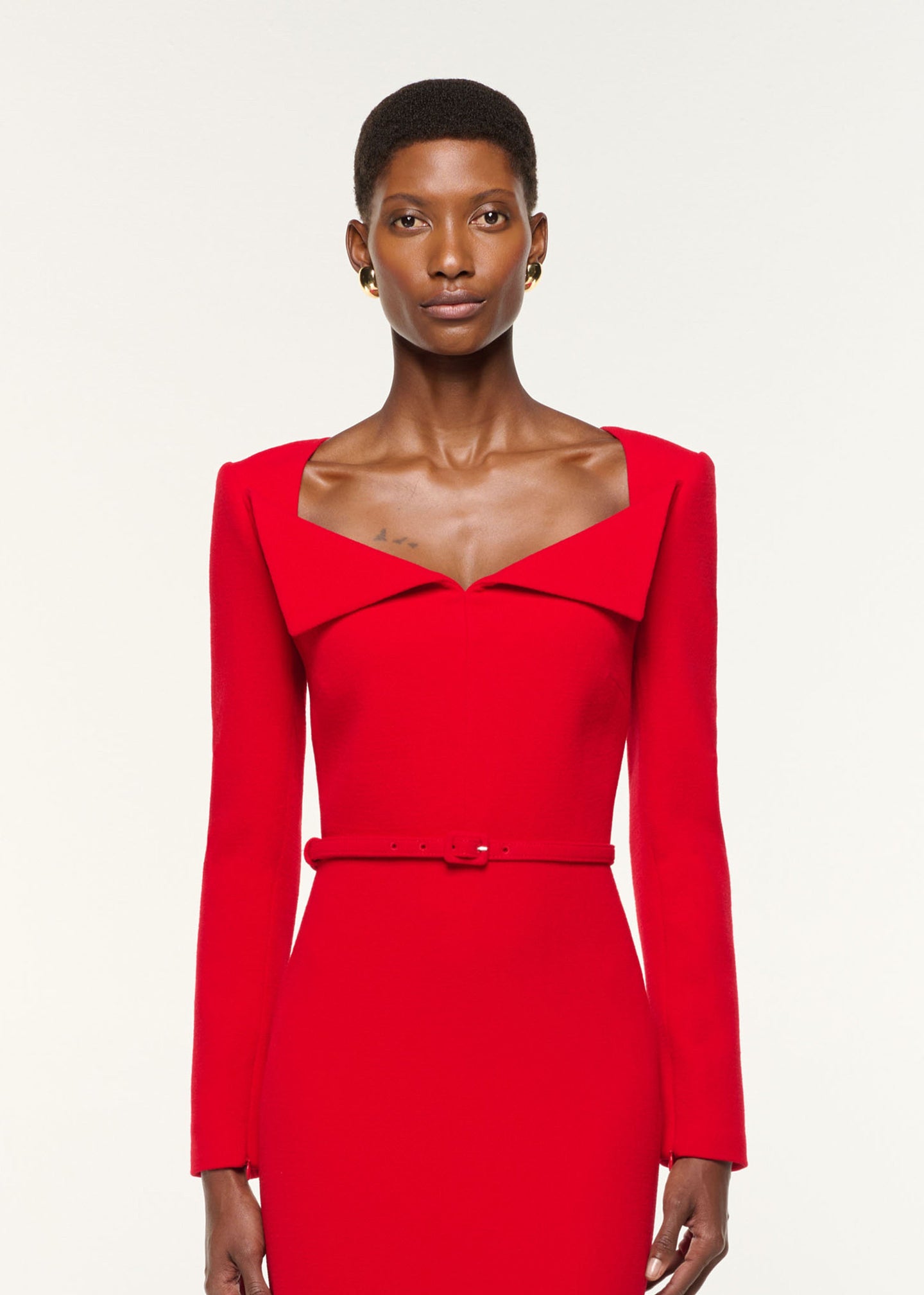 Close up of a model wearing the Square Neck Collar Fold Wool Crepe Dress in Red