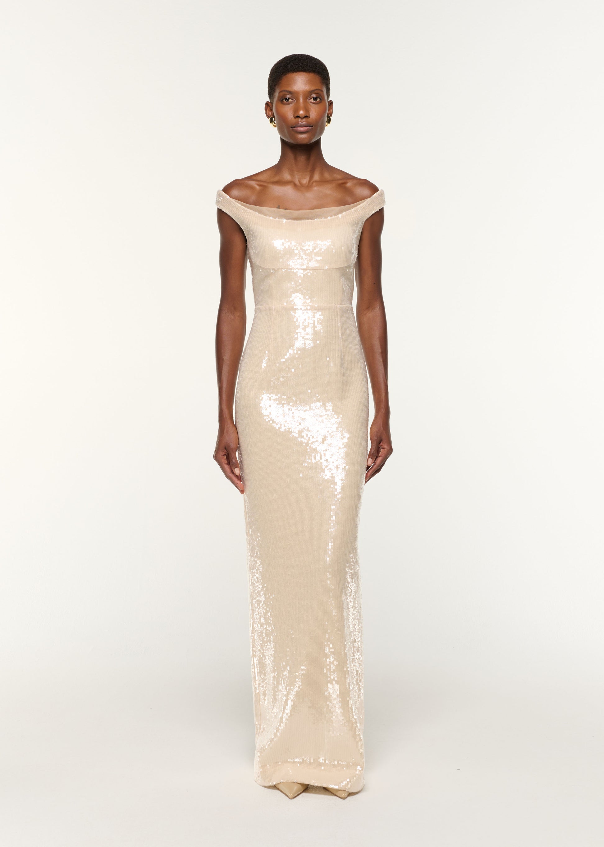 Front view of a model wearing the Off The Shoulder Sequin Gown in Cream