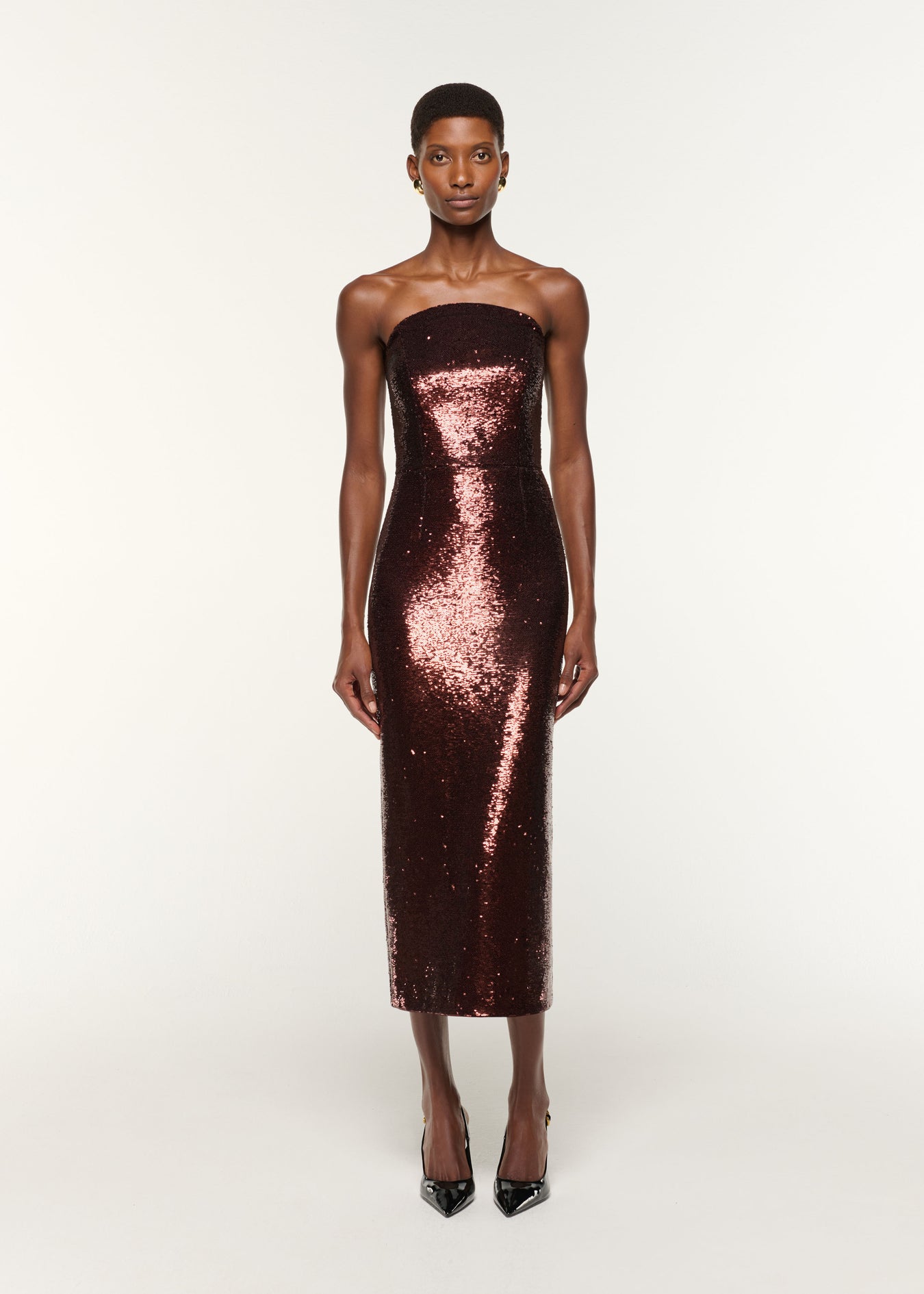 Front view of a model wearing the Curved Neck Sequin Midi Dress in Brown