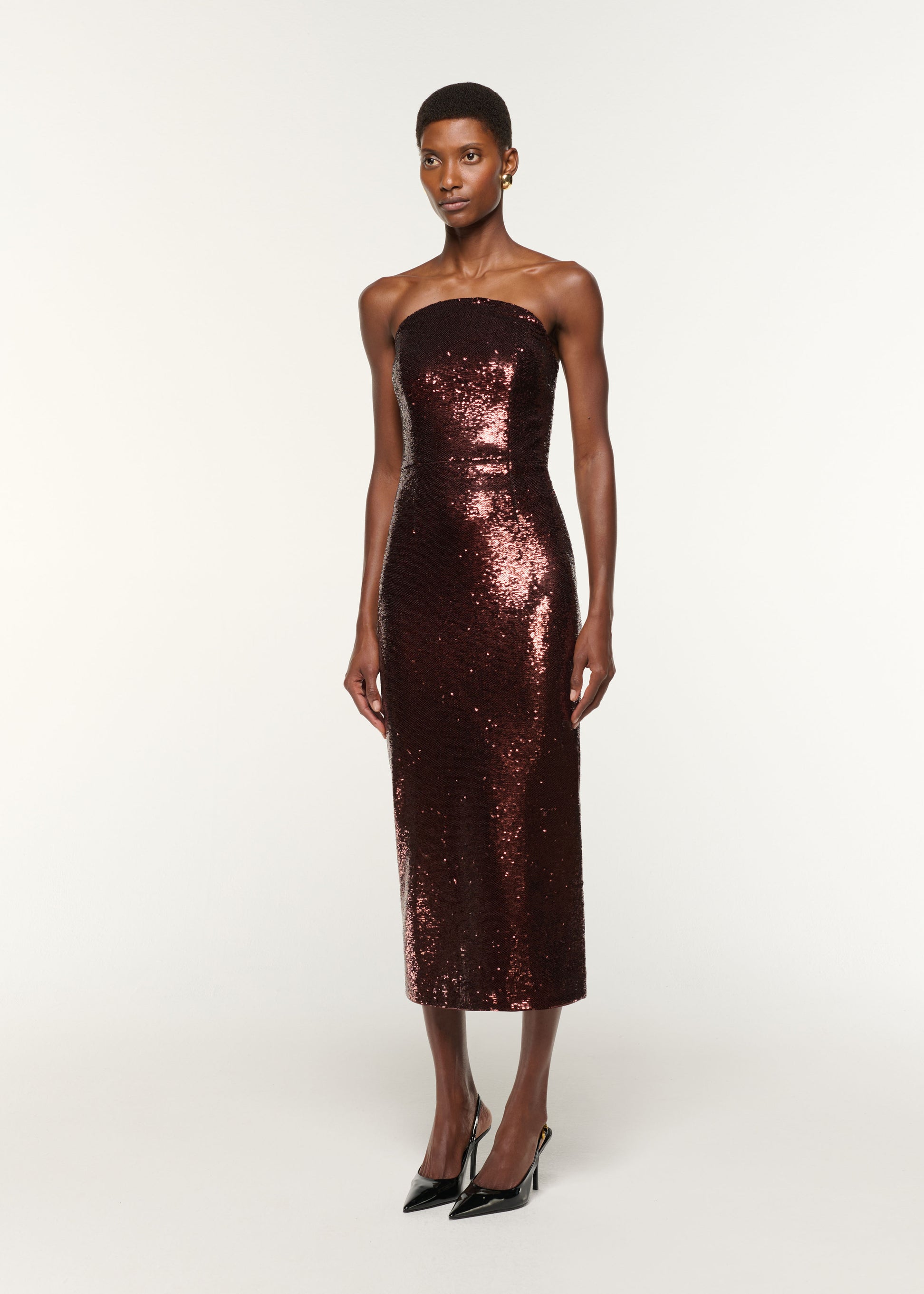 Side view of a model wearing the Curved Neck Sequin Midi Dress in Brown
