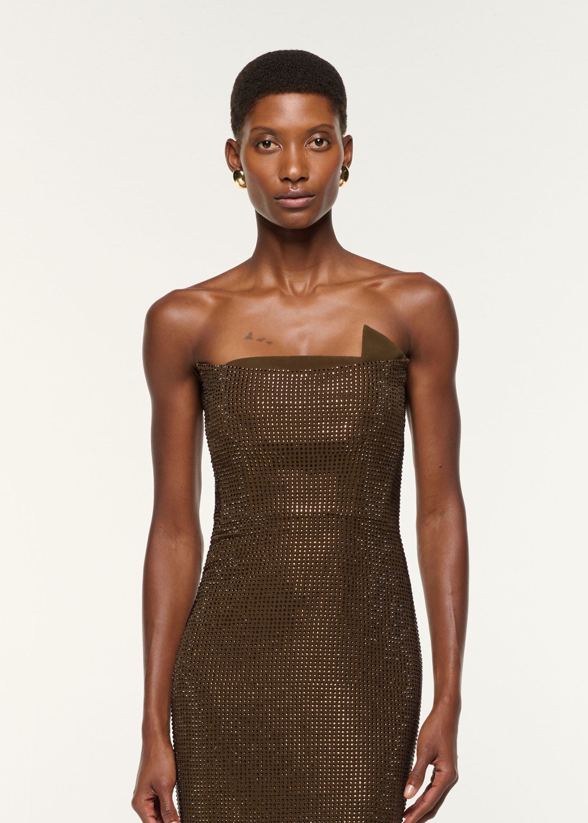 Close up of a model wearing the Strapless Diamante Gown in Khaki