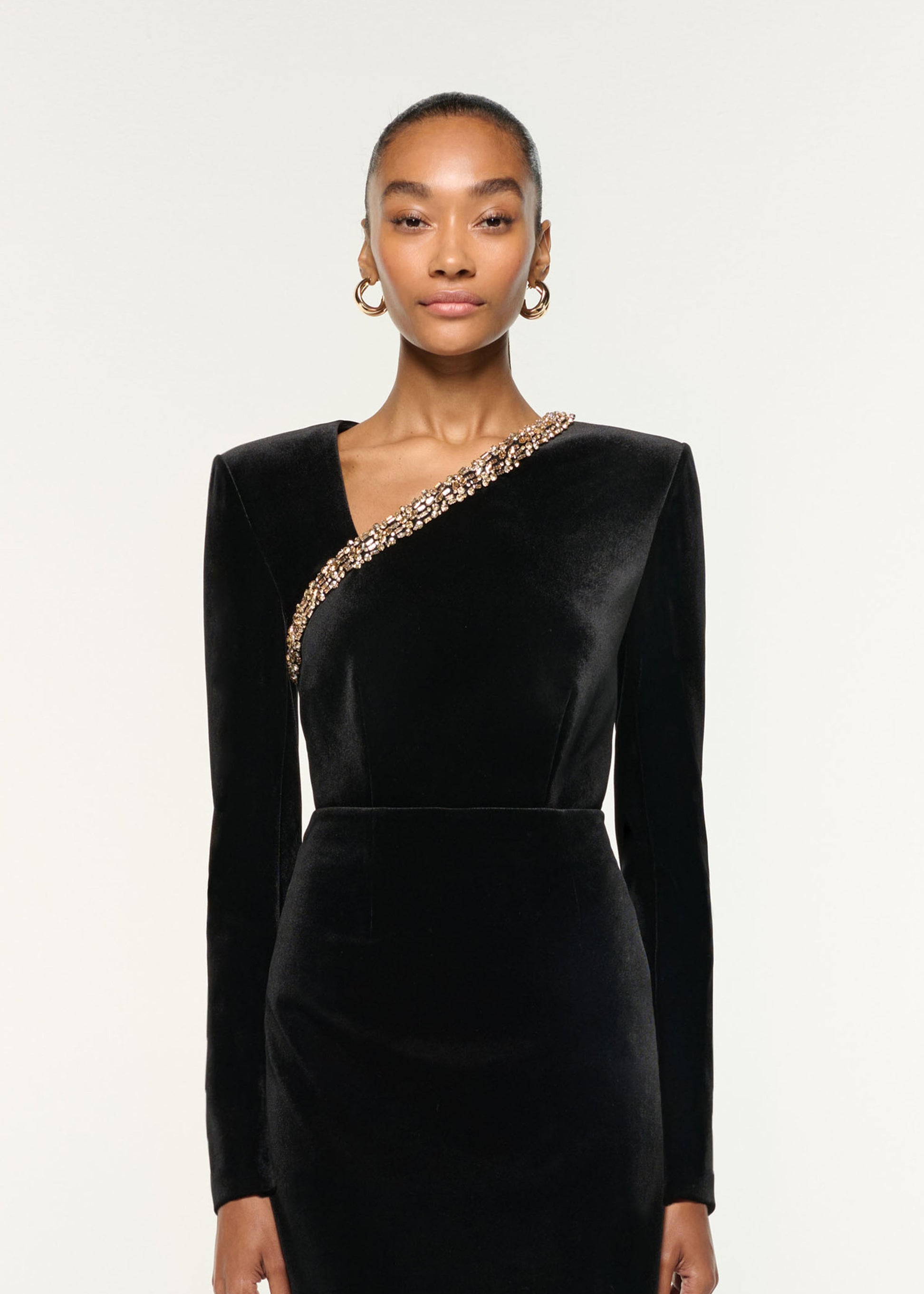 Close up of a model wearing the Long Sleeve Embellished Velvet Top in Black