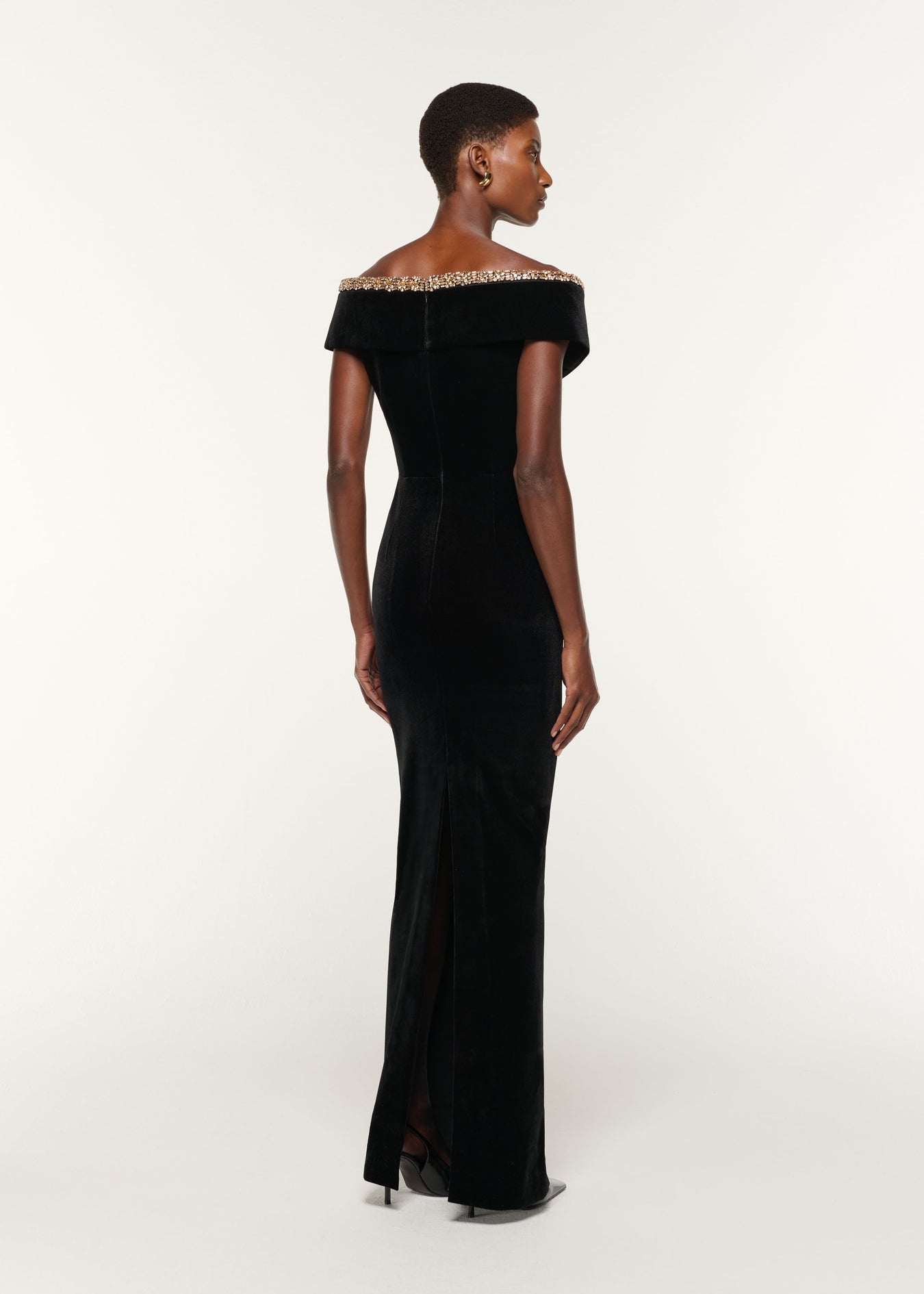 Back view of a model wearing the Velvet Diamante Crossover Gown in Black