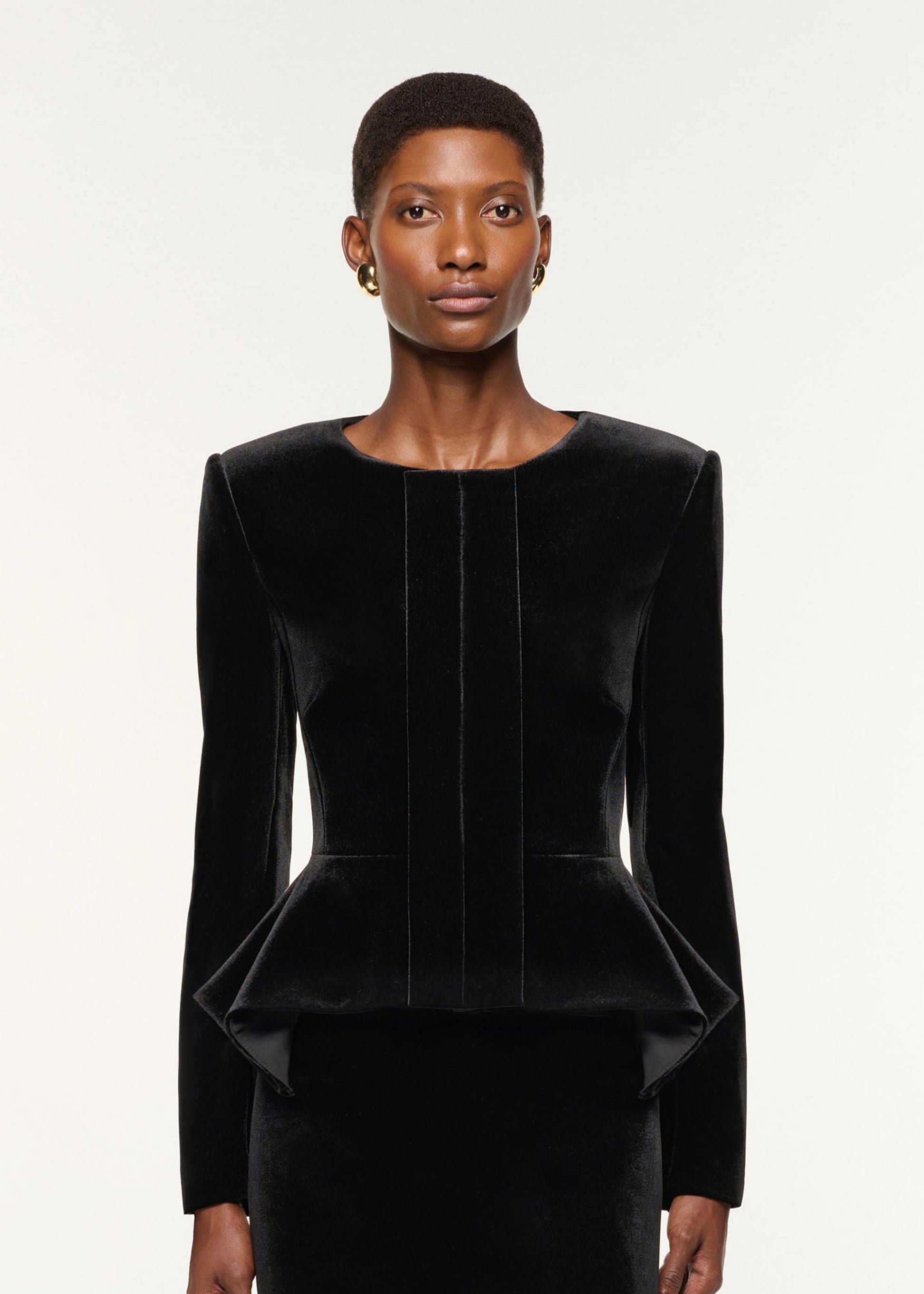 Close up of a model wearing the Velvet Midi Skirt in Black