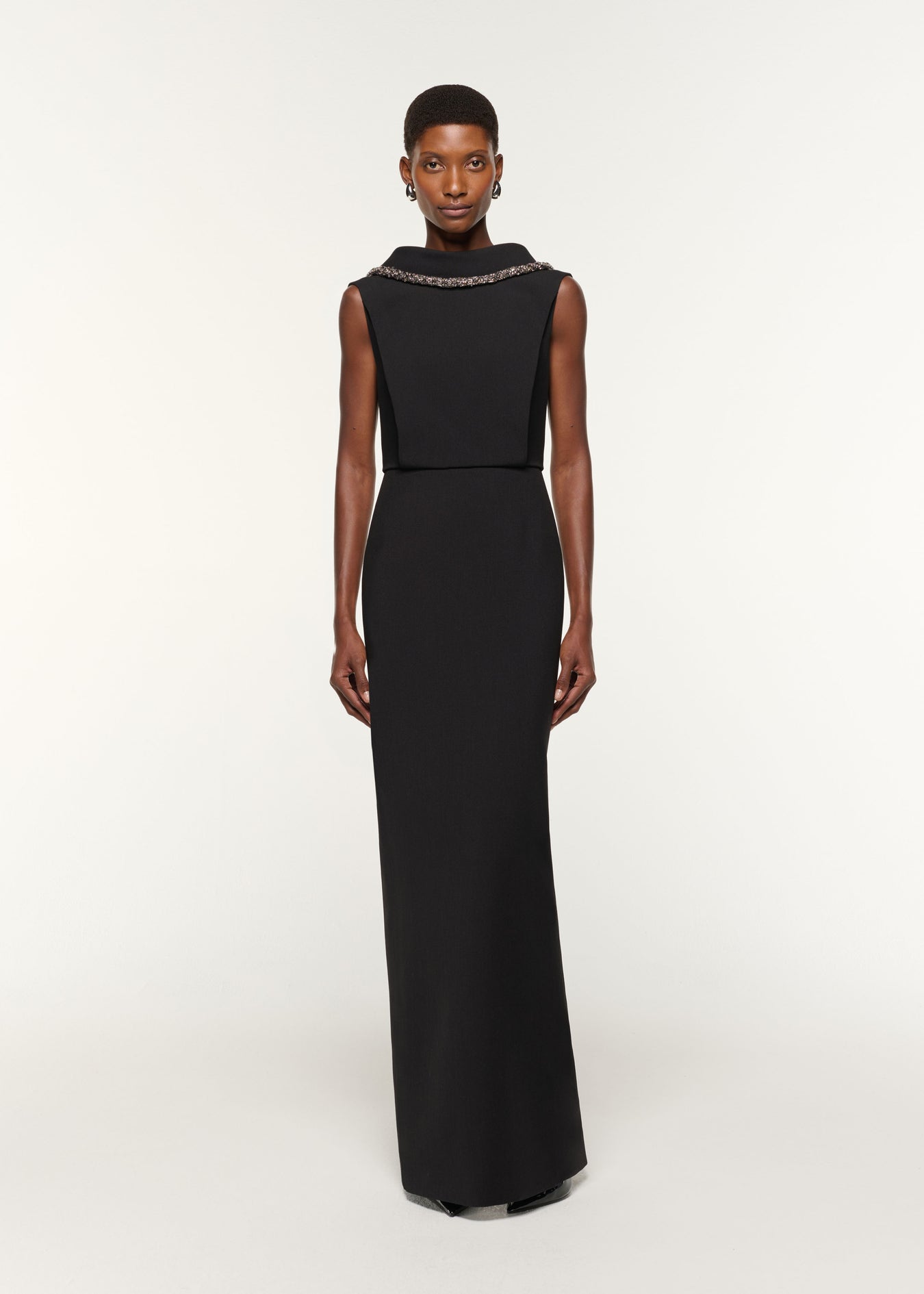 Front view of a model wearing the Diamante Roll Neck Crepe Gown in Black