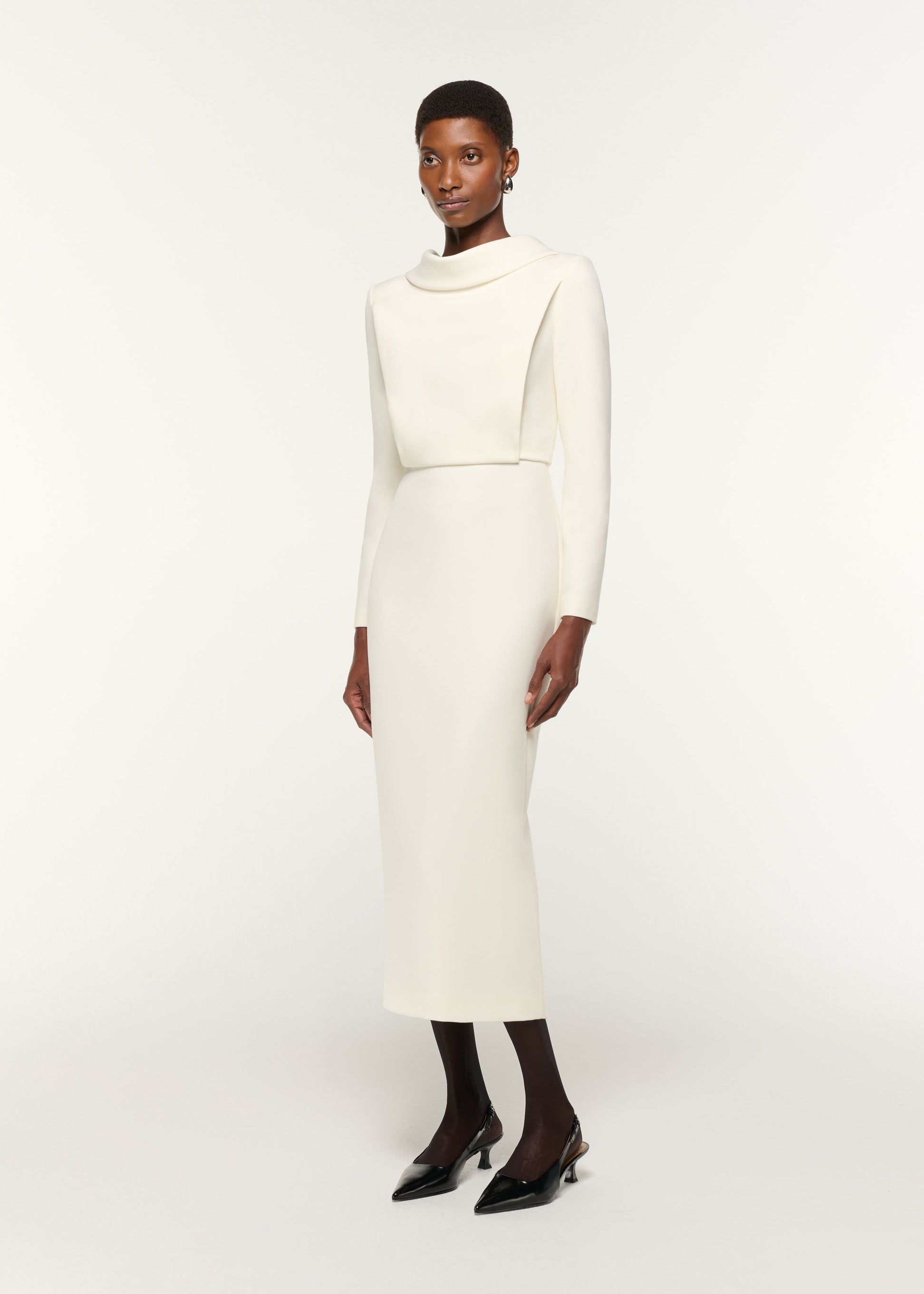 Side view of a model wearing the Collared Crepe Midi Dress in Cream