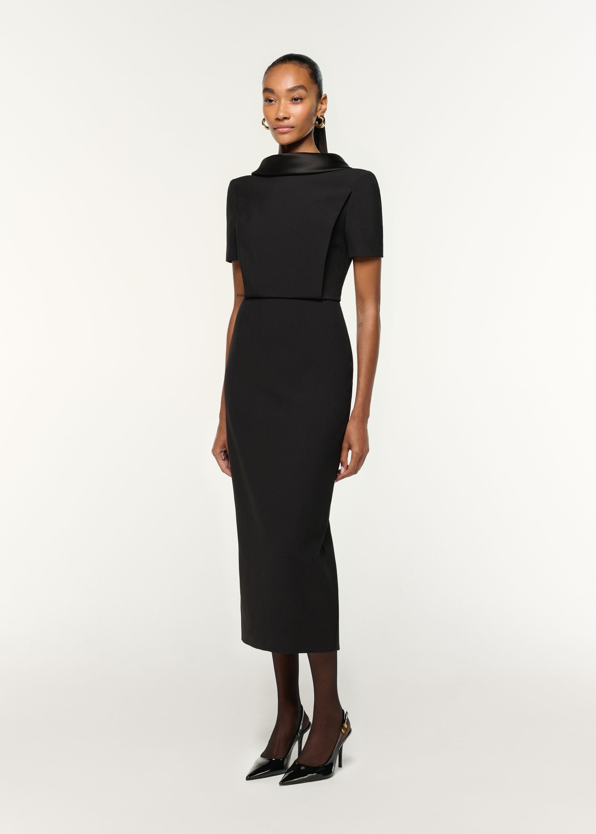 Side view of a model wearing the Collared Crepe Midi Dress in Black