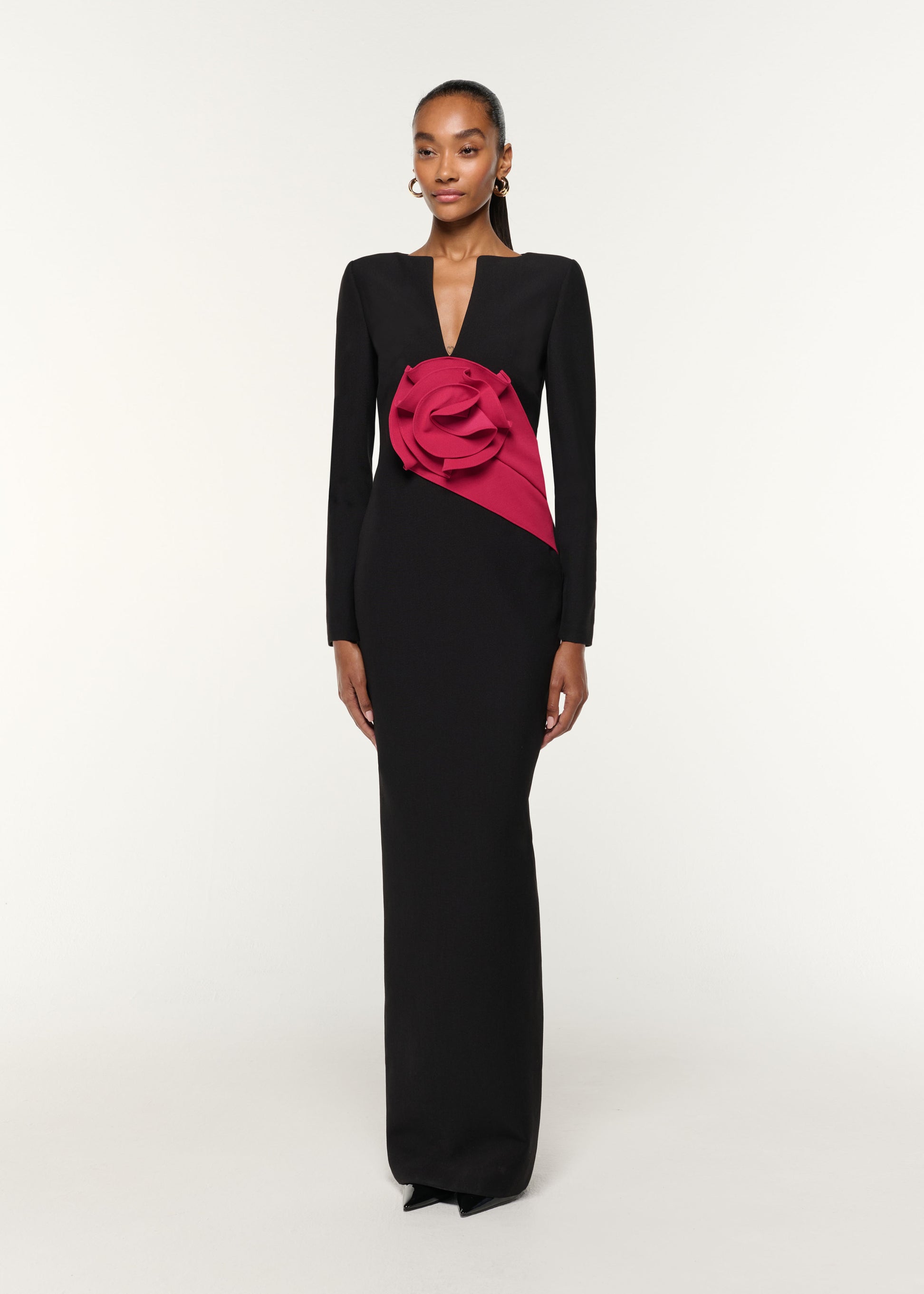 Side view of a model wearing the Flower Drape Crepe Gown in Black