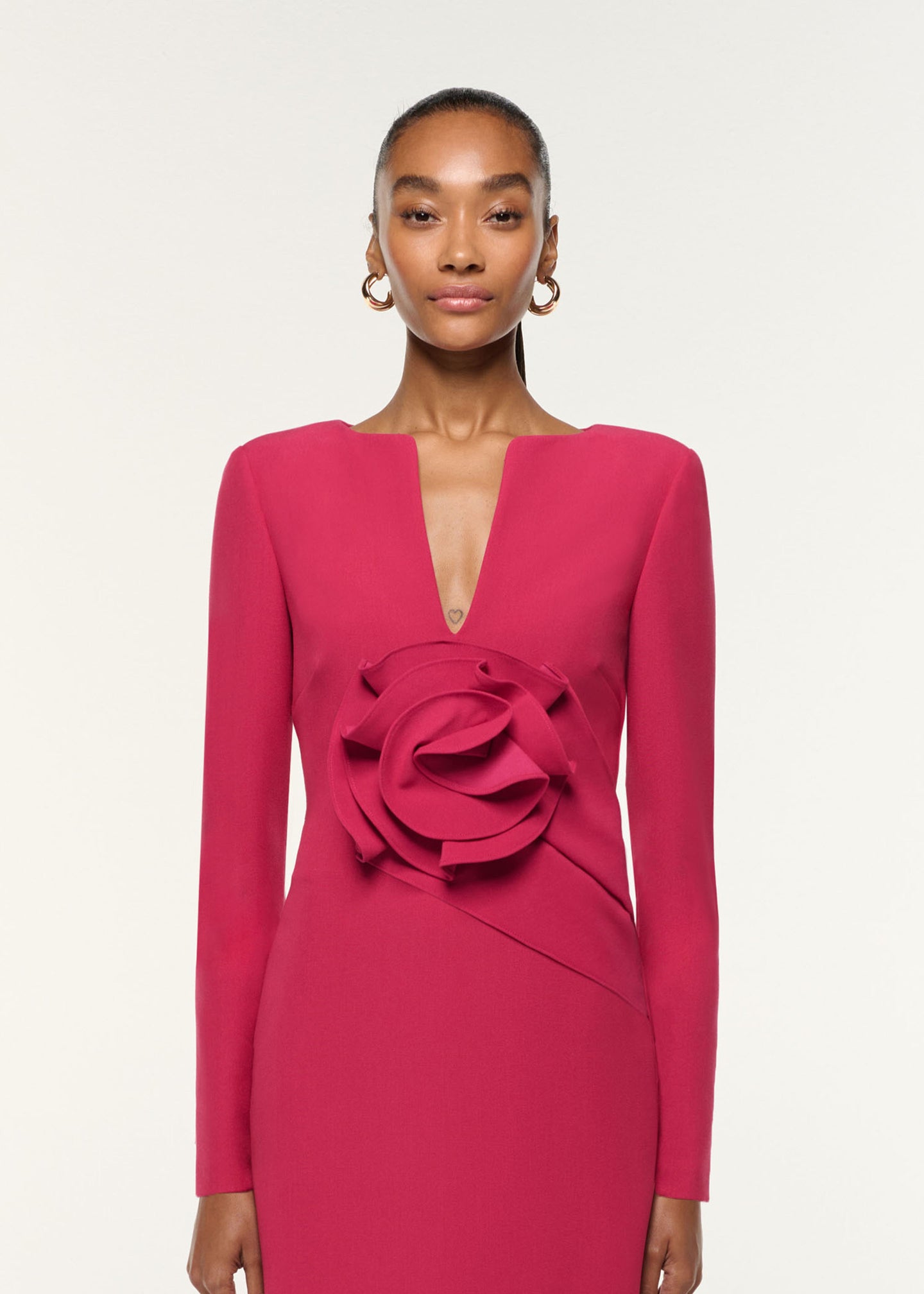 Close up of a model wearing the Flower Drape Crepe Midi Dress in Pink