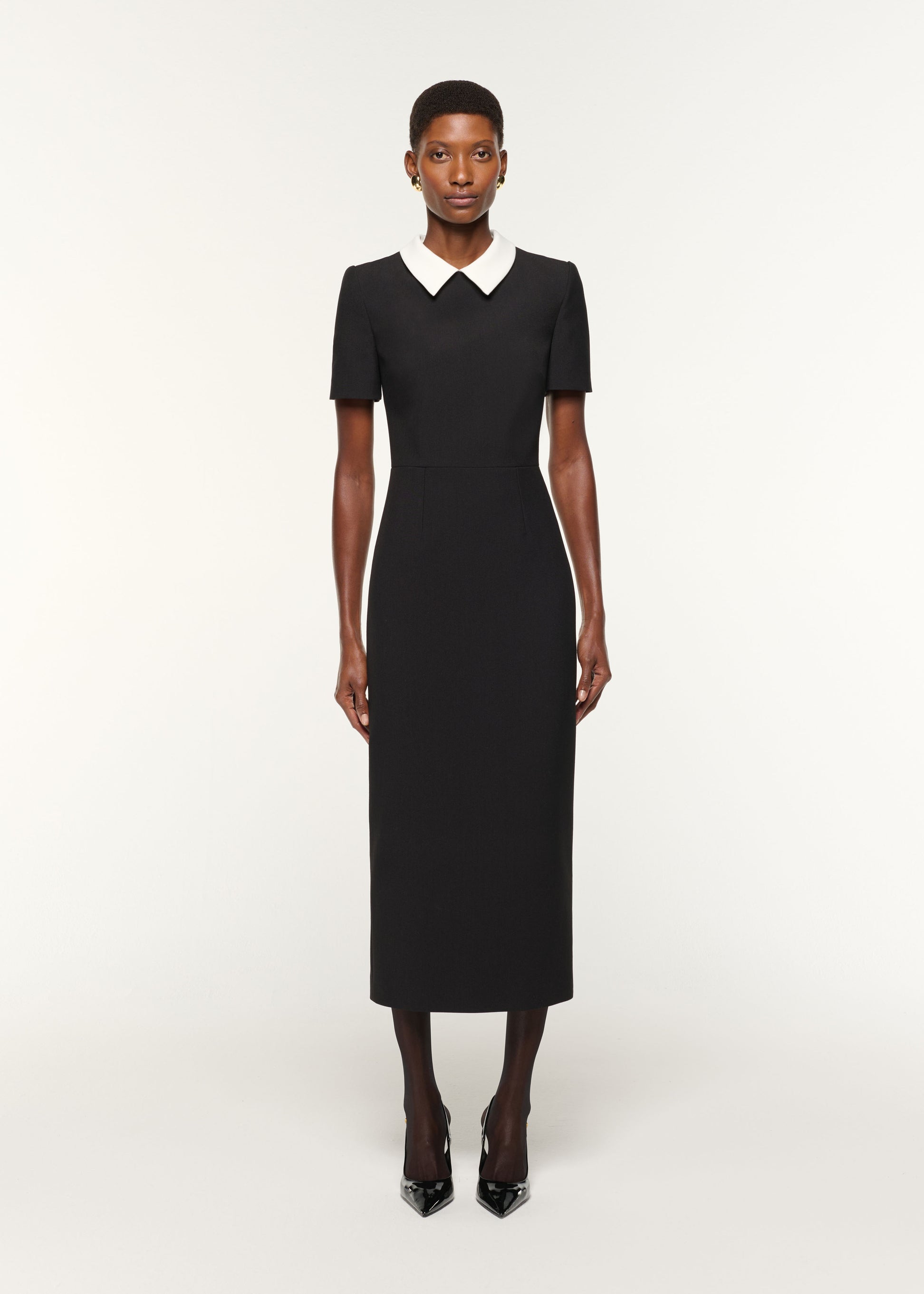 Front view of a model wearing the Contrast Collar Crepe Midi Dress in Black