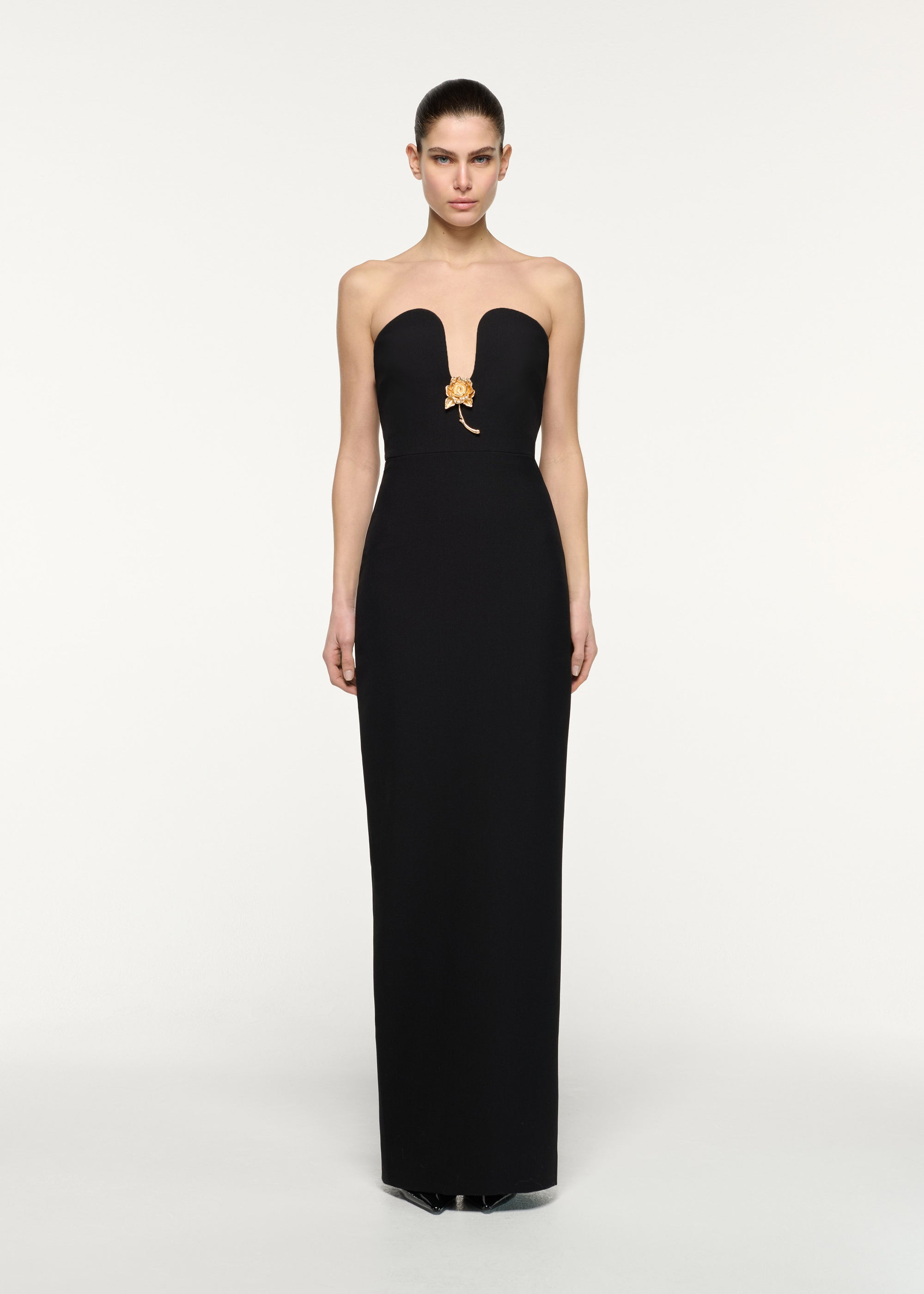 Front view of a model wearing the Gold Rose Brooched Plunge Dress in Black