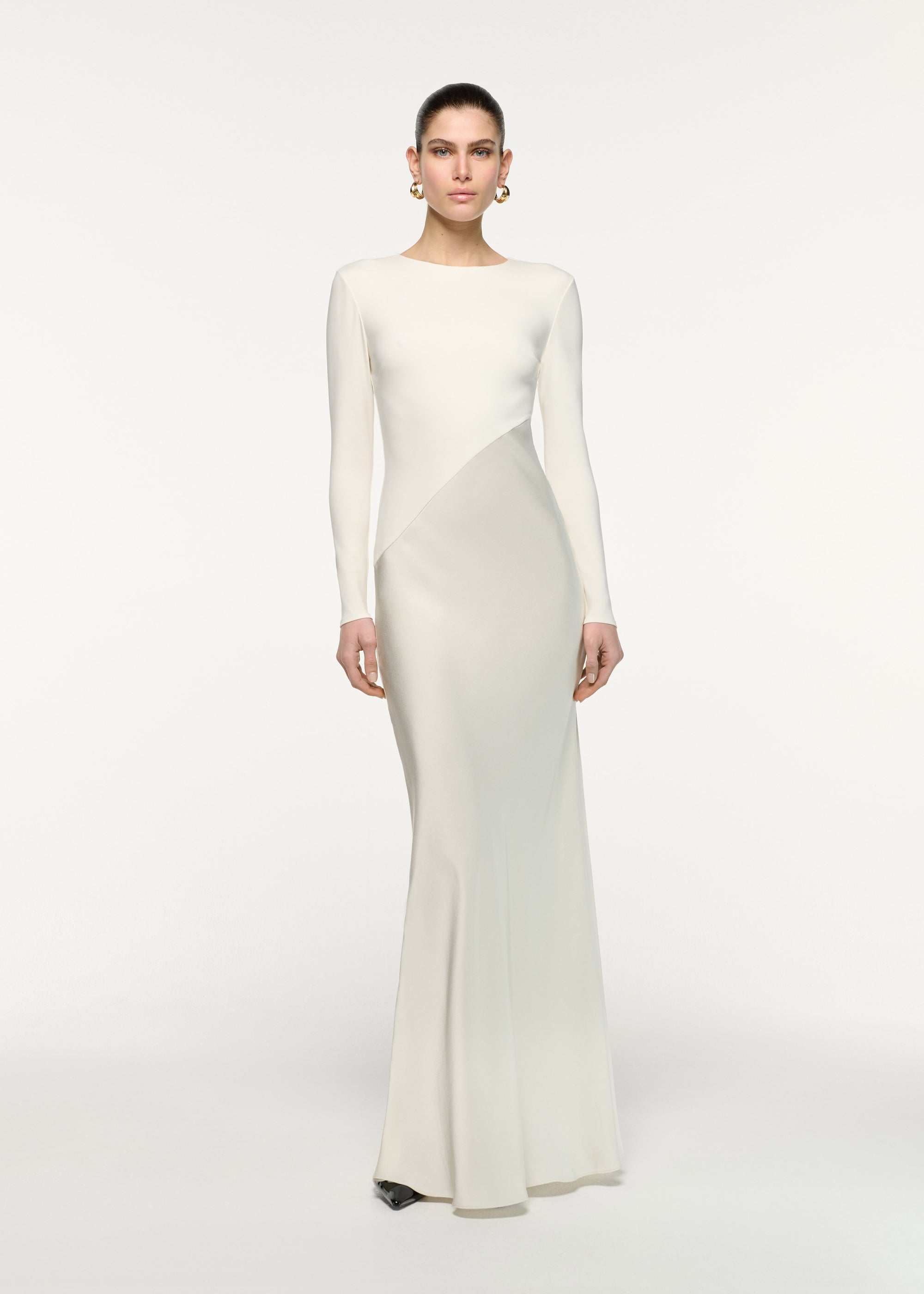 Front view of a model wearing the Asymmetric Contrast Fabric Gown in Cream 