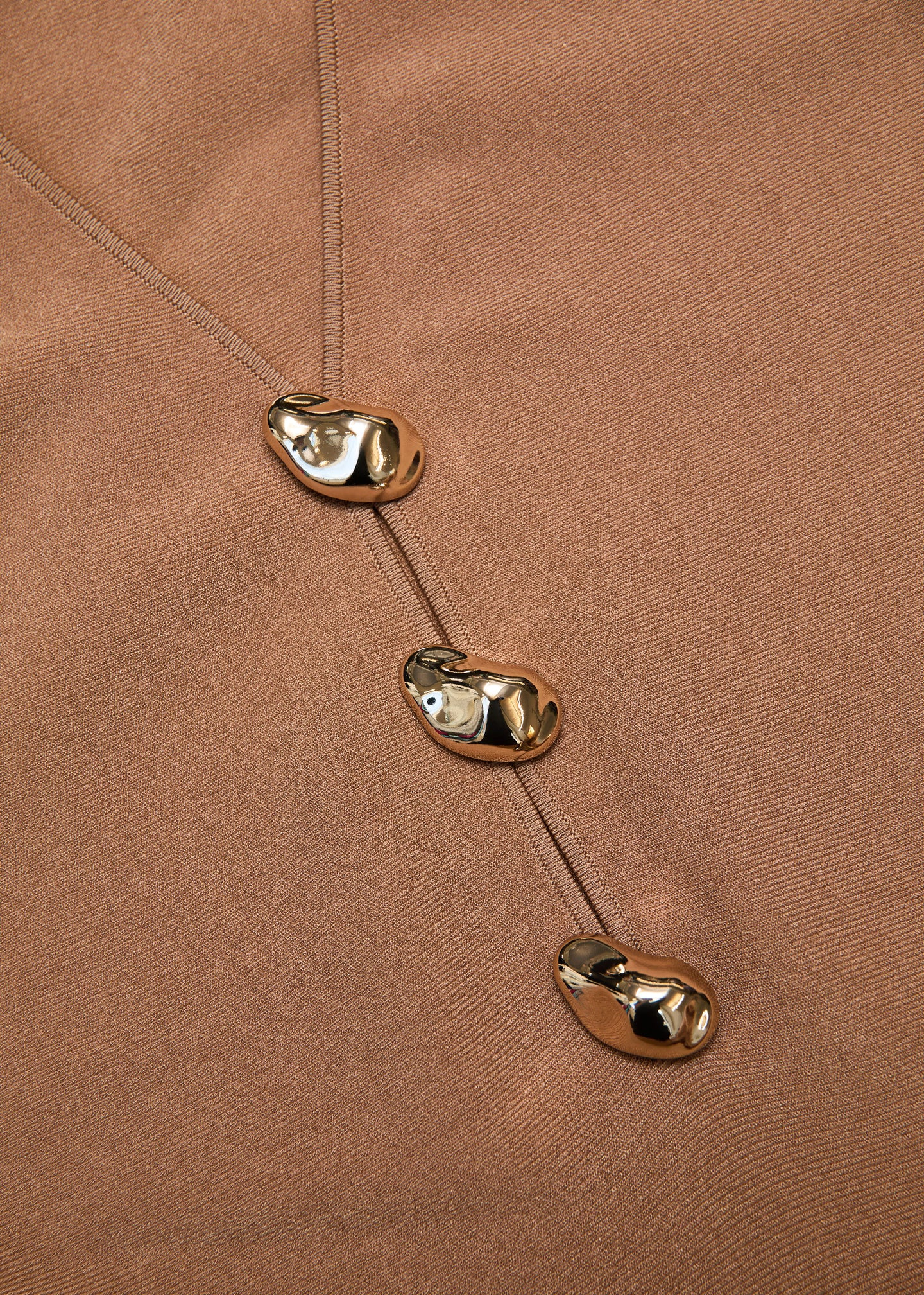 A close up of the fabric for the Pebble Trimmed Knit Dress in Camel