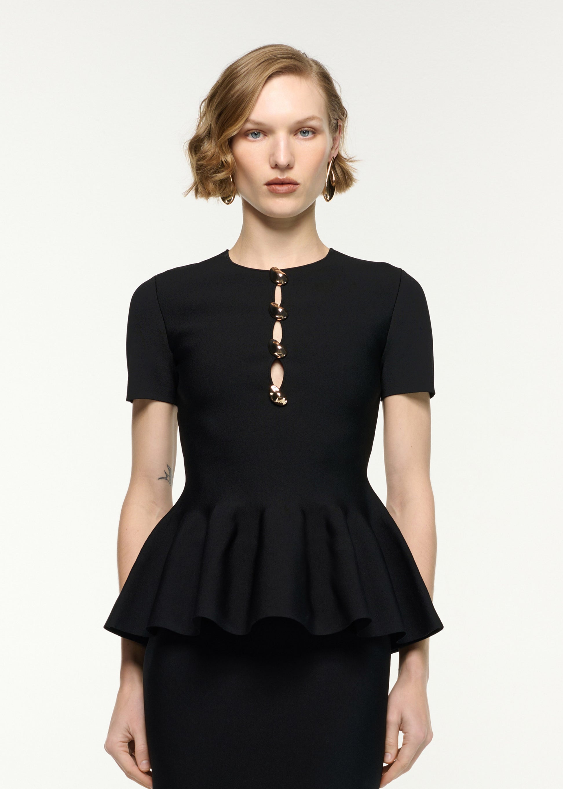 Close up of a model wearing the Pebble Trimmed Knit Top in Black