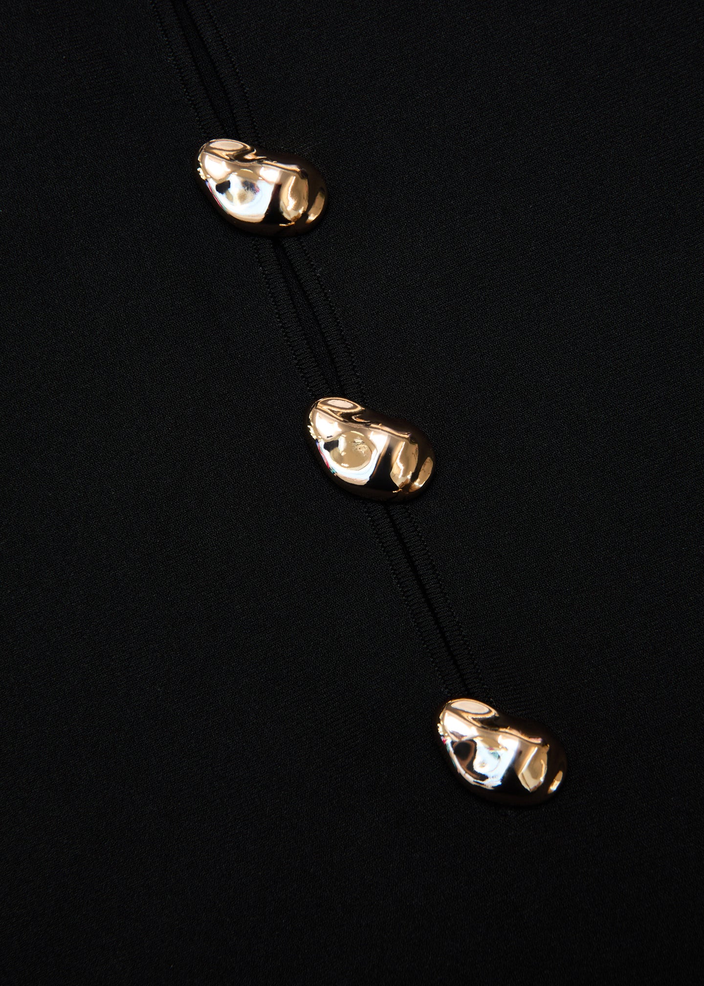 A close up of the fabric for the Pebble Trimmed Knit Top in Black