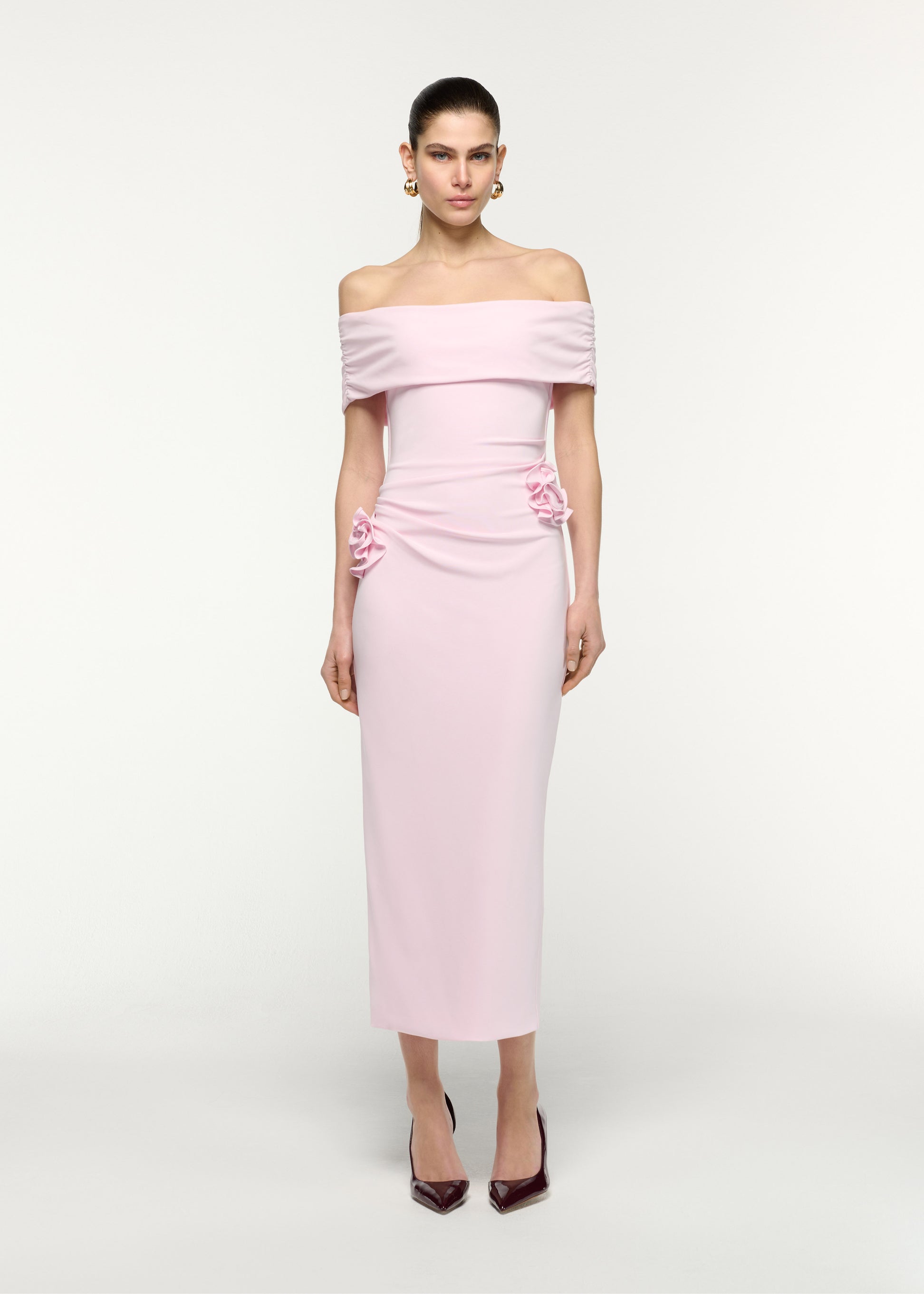 Front view of a model wearing the Off The Shoulder Flower Jersey Dress in Pink