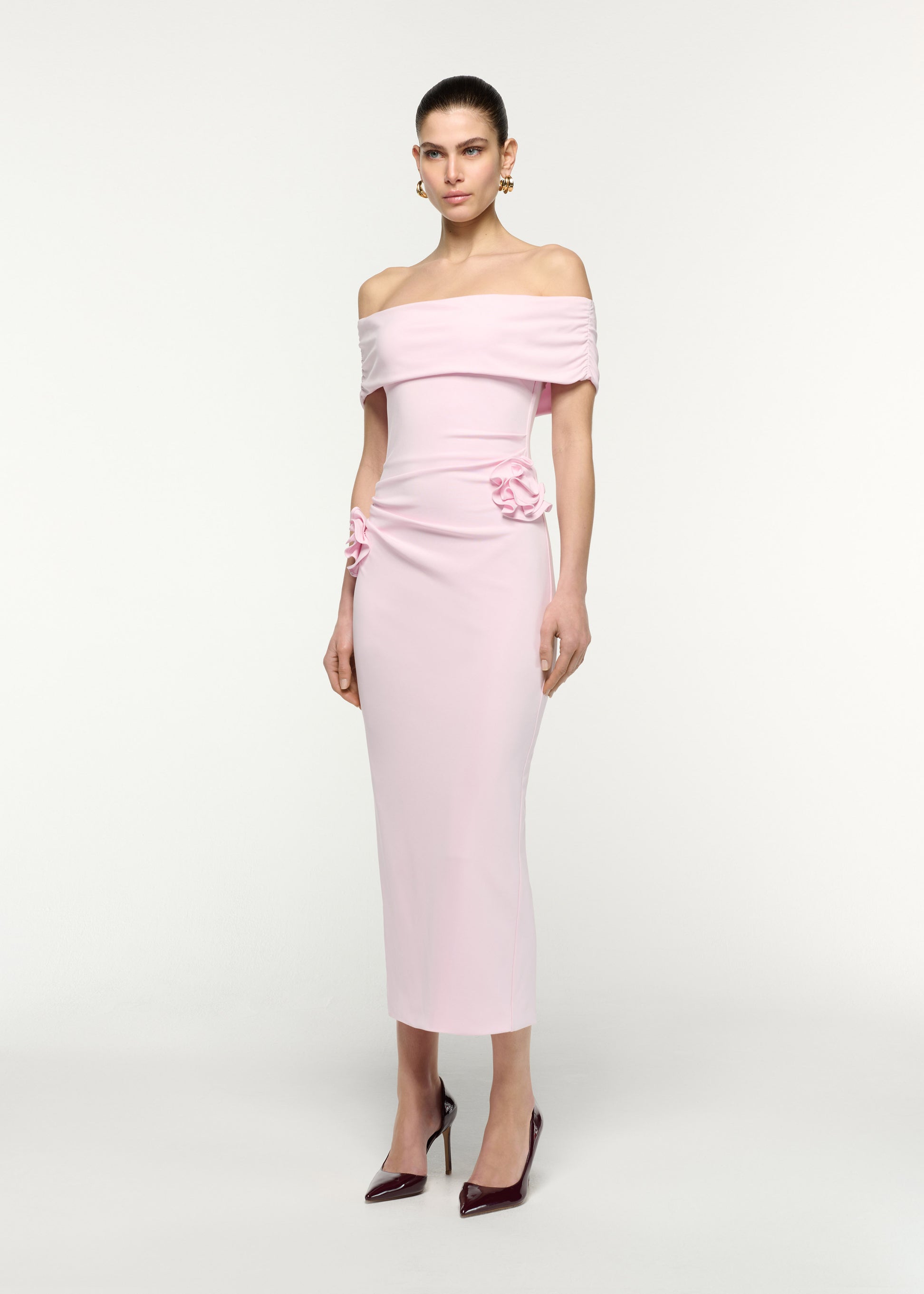 Side view of a model wearing the Off The Shoulder Flower Jersey Dress in Pink
